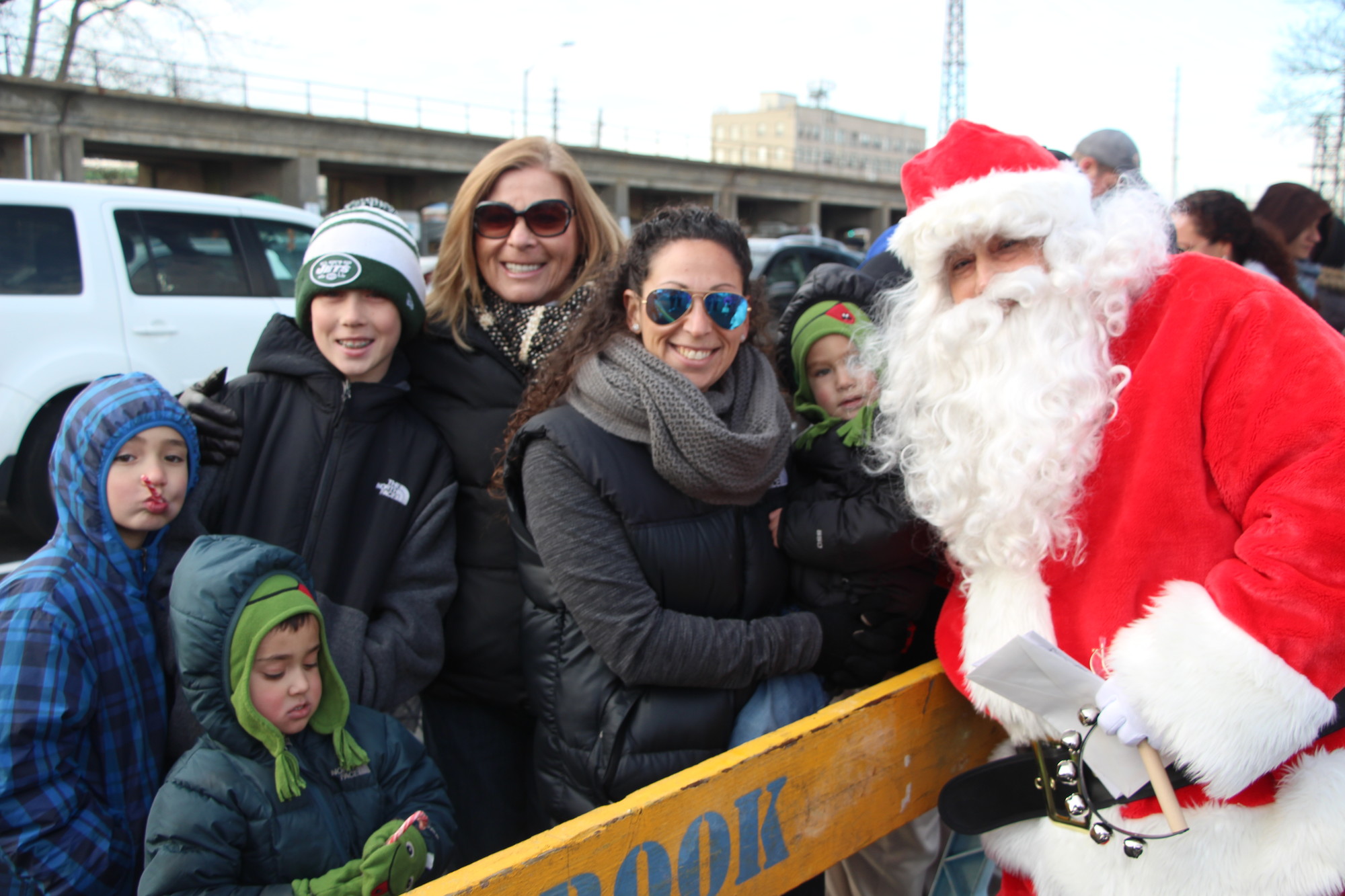 Local families greeted Santa when he arrived early last Saturday morning on a Lynbrook fire truck. Pictured from left were brothers Kaden, Max and Jack Rogers, their grandmother Rhonda Glickman, her daughter Shari Bowes, and Bowes’s son, Ryan.