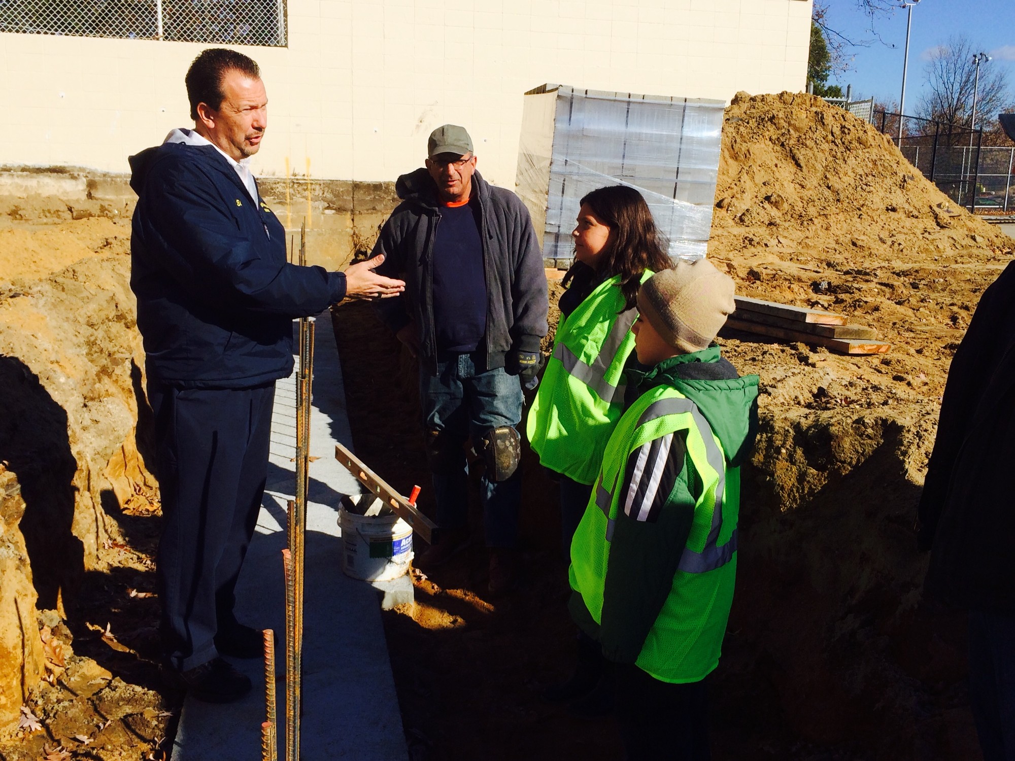 Valley Stream Mayor Ed Fare stood in the foundation of a new sun and shade deck at the Hendrickson Park Pool while he explained the ongoing construction to Lauren Flynn and Brandon Dikeman, Valley Stream’s mayors for a day.