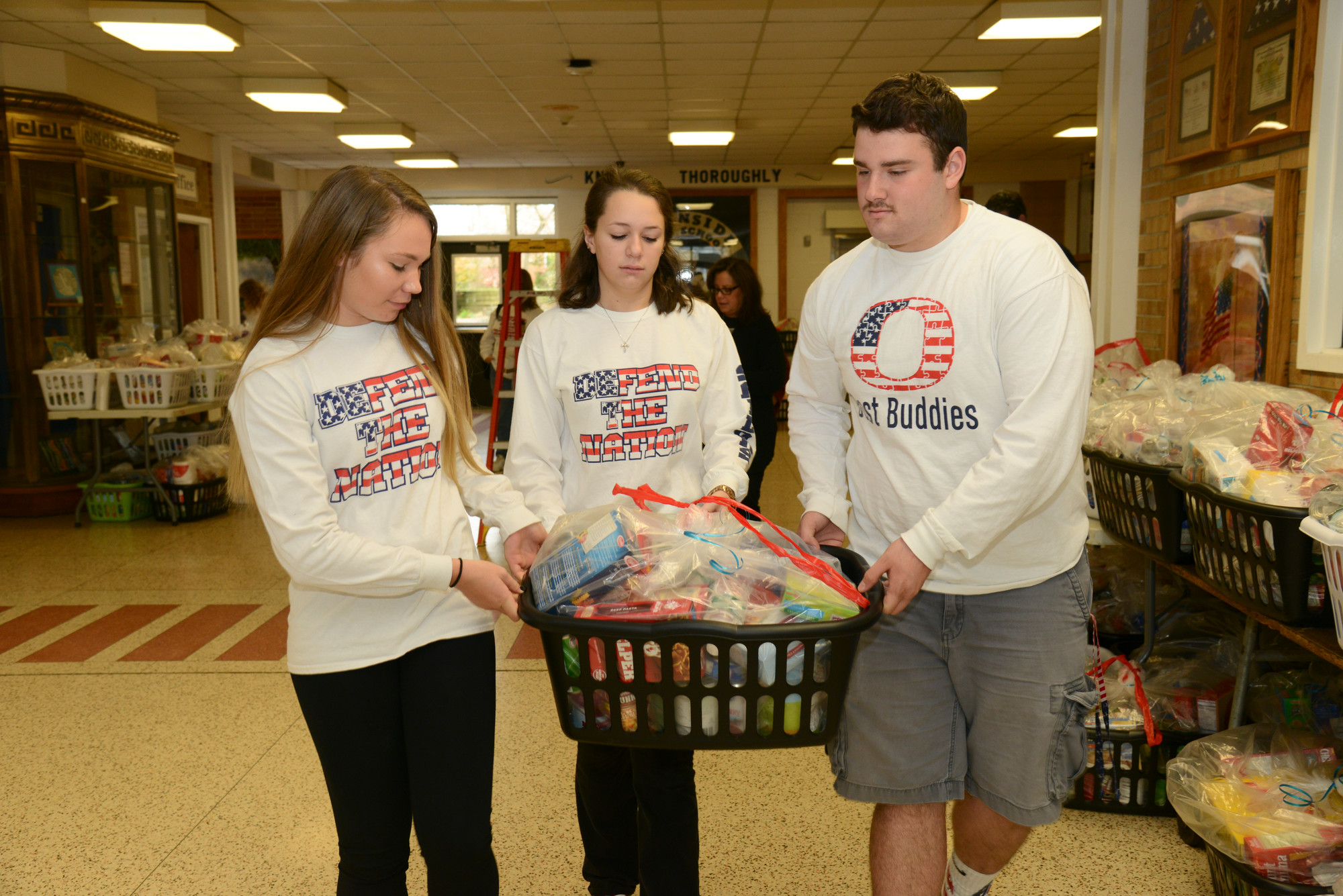Jessica Schwartz, Jessica Scandiffio, and Matt Kear arranging baskets for delivery at the OHS turkey Shoot.