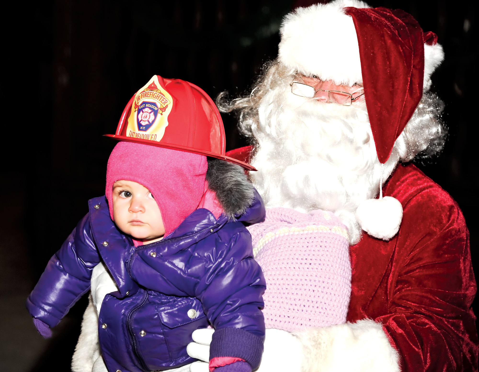Julia Terzulli, 10 months old and a junior firefighting in training, sat with Santa.