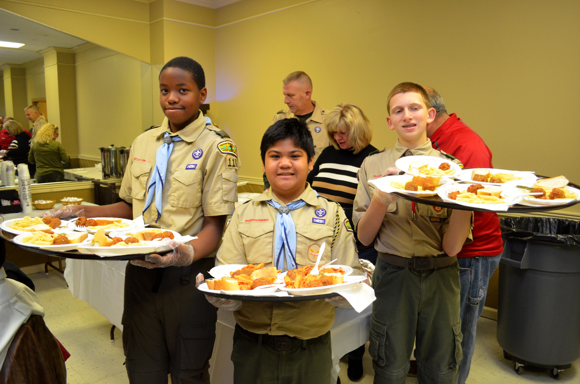Members of Troop 116 serving food at the party.  Akin Olowofela, Brandon Yu and Jason Bitetto.