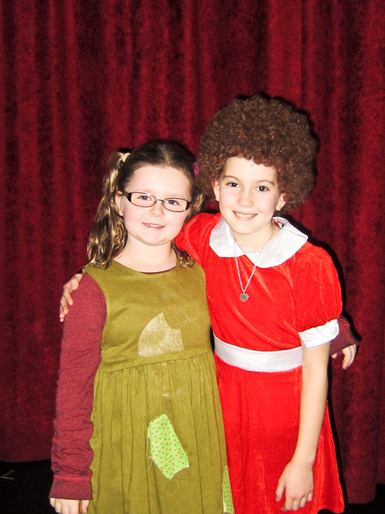 There’s always “tomorrow” for eight-year-old Katie DiIorio, left, who appears as Molly, with Ava Casiano, starring as Annie, in the Merrick Theatre & Center for the Arts’ staging of the beloved musical this month.