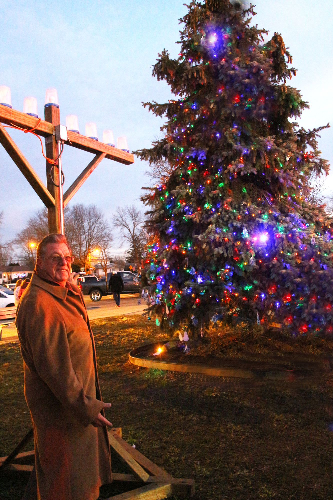 Former East Meadow School District Superintendent Leon Campo took in the     festive holiday scenery in Salisbury last Friday at the Community Association of Stewart Avenue’s annual Christmas tree and menorah lighting.