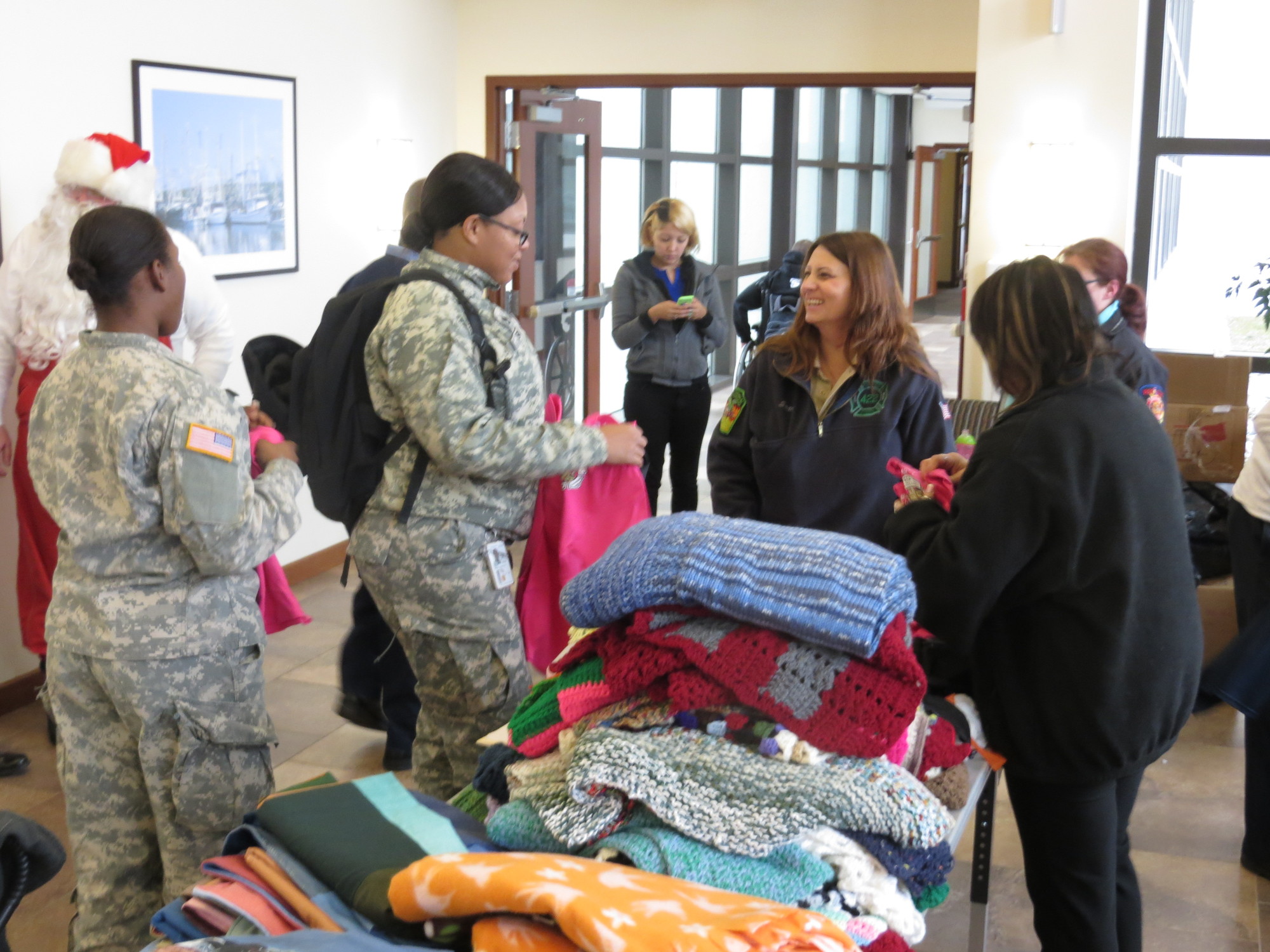 Military personnel looked over the handmade blankets that were donated to the wounded at the hospital.