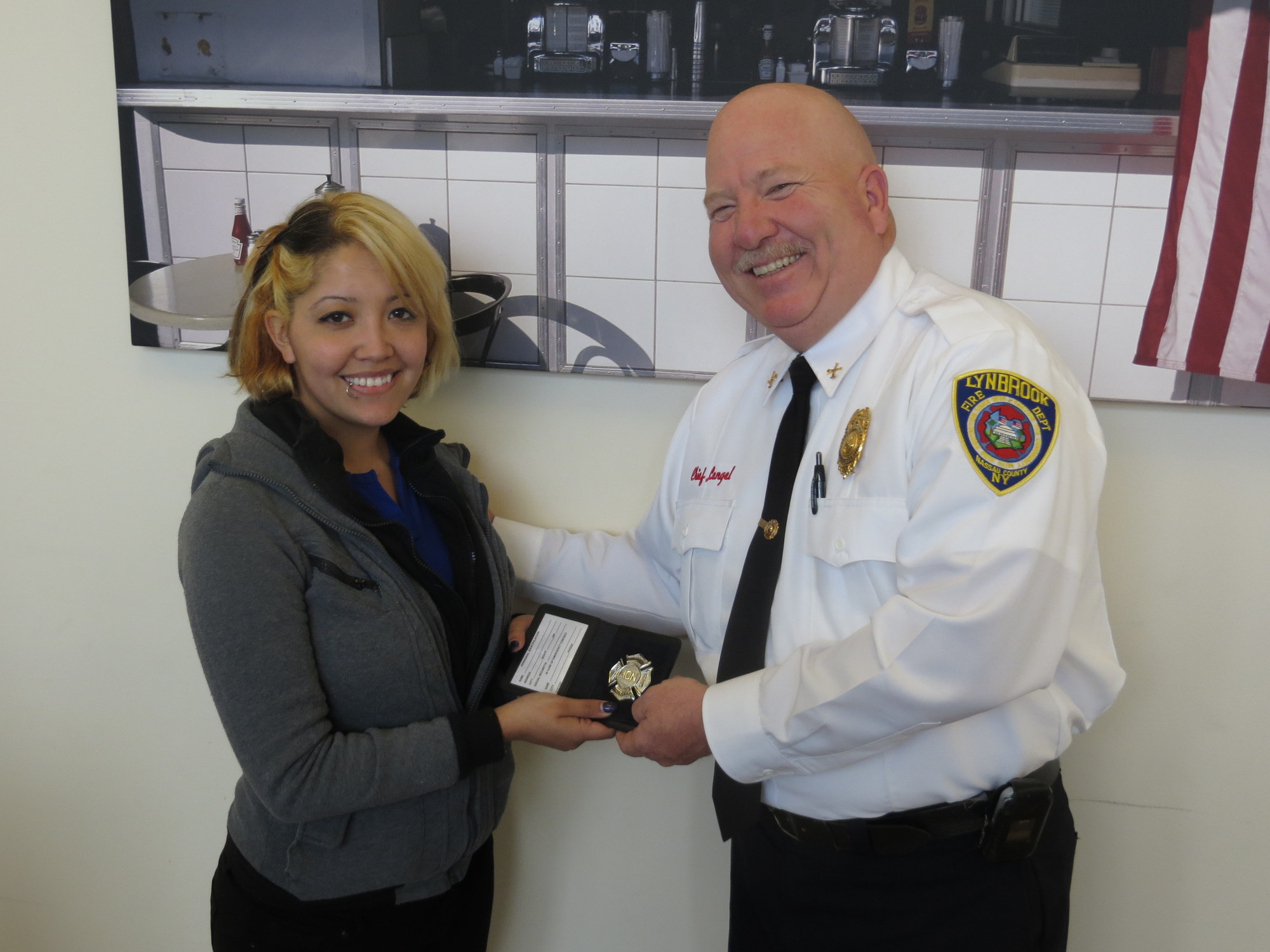 Chief Lengel presented Marcos Dandrea’s honorary Lynbrook Fire Department badge to his wife, Victoria.