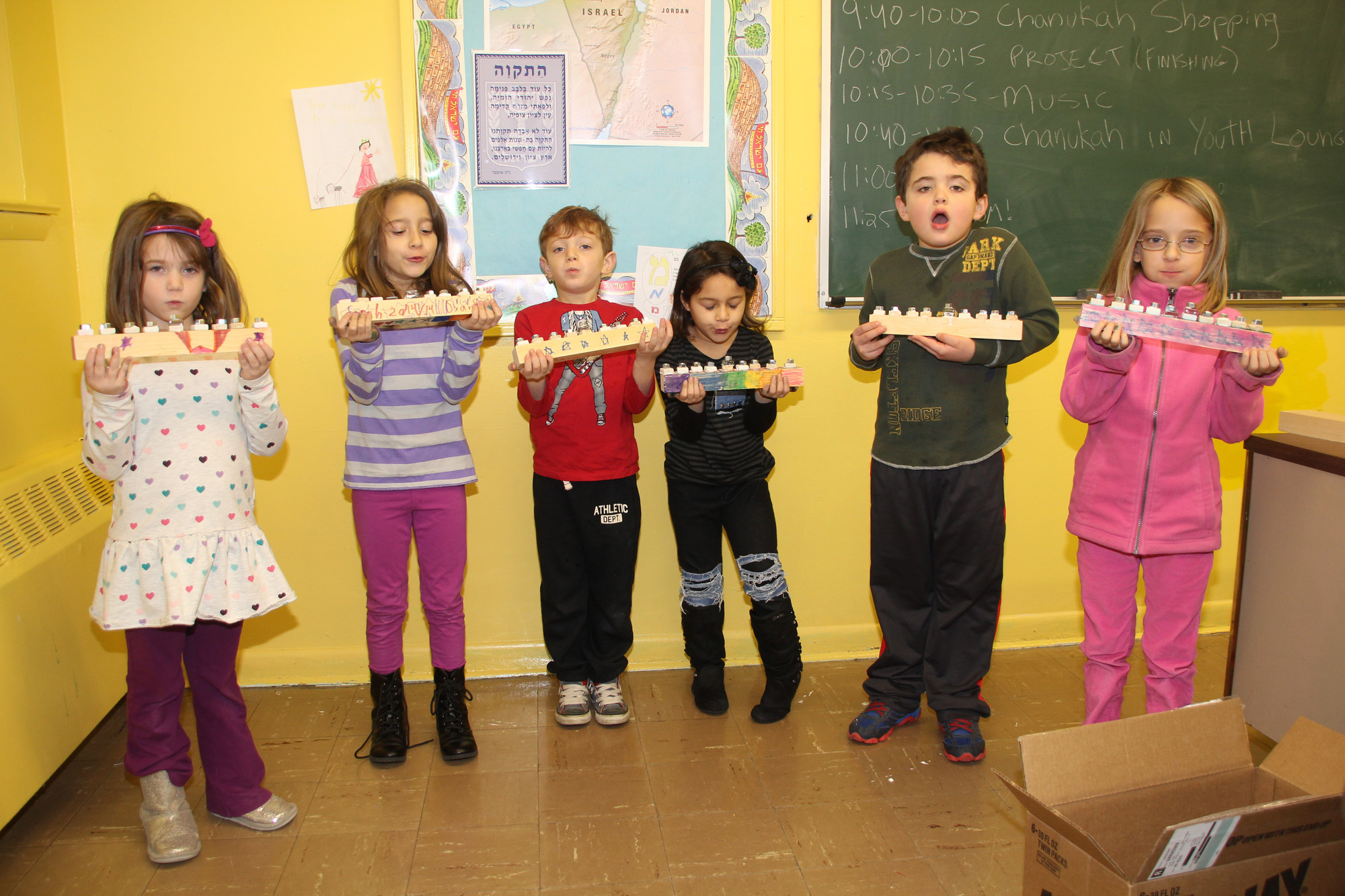 Children show the Hanukkah Candles that they made at the fair.