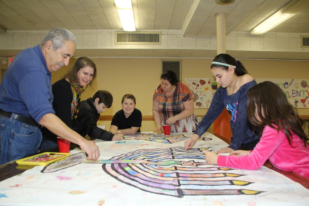 Temple members of all ages helped make a menorah poster.