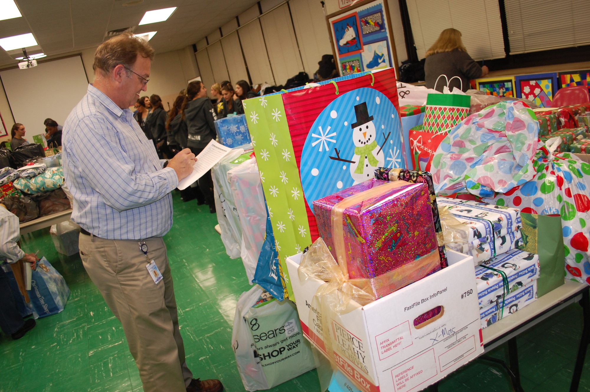Technology specialist Leo Vanderburg checked over the donations for students at Lee Road Elementary School.