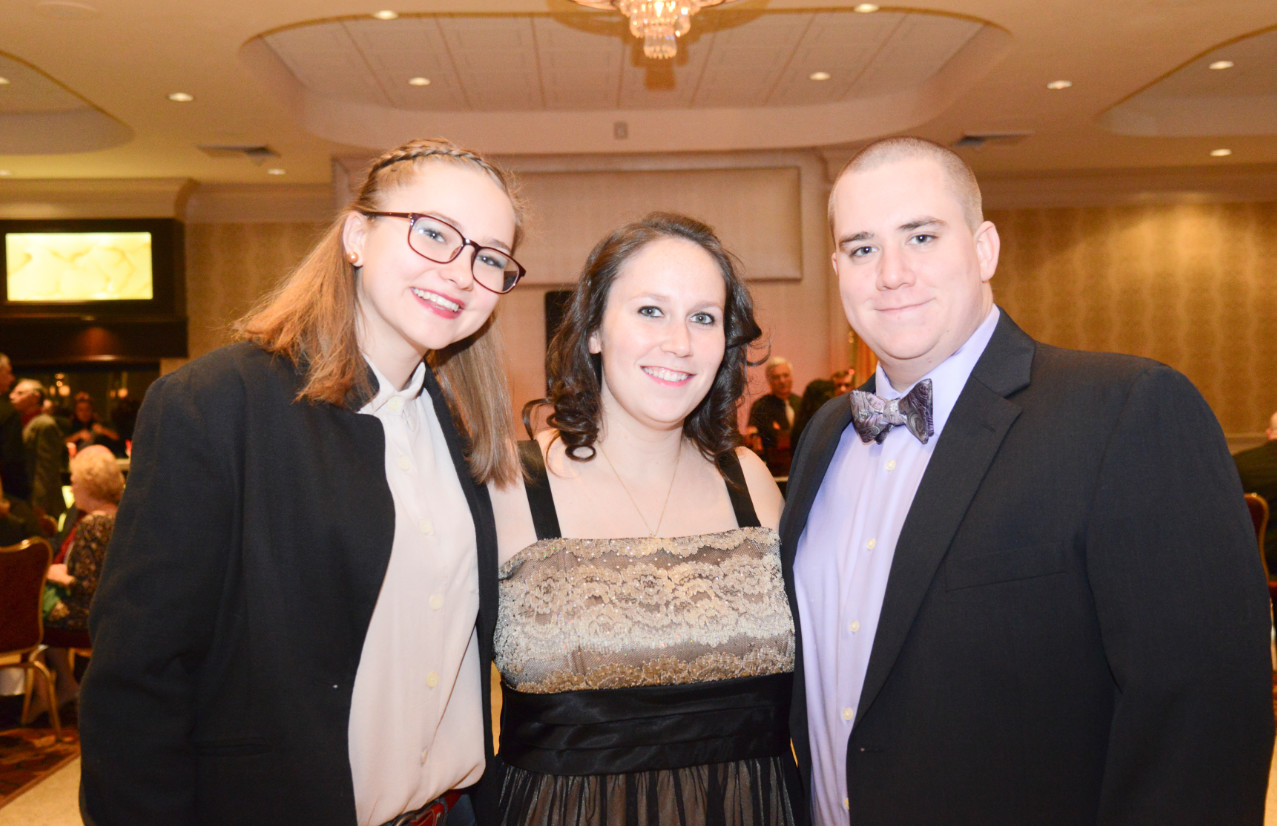 Jessica Caraciolo, Jessica Brown, and Steven Peppe enjoy cocktail hour at the holiday party at Knights of Columbus.