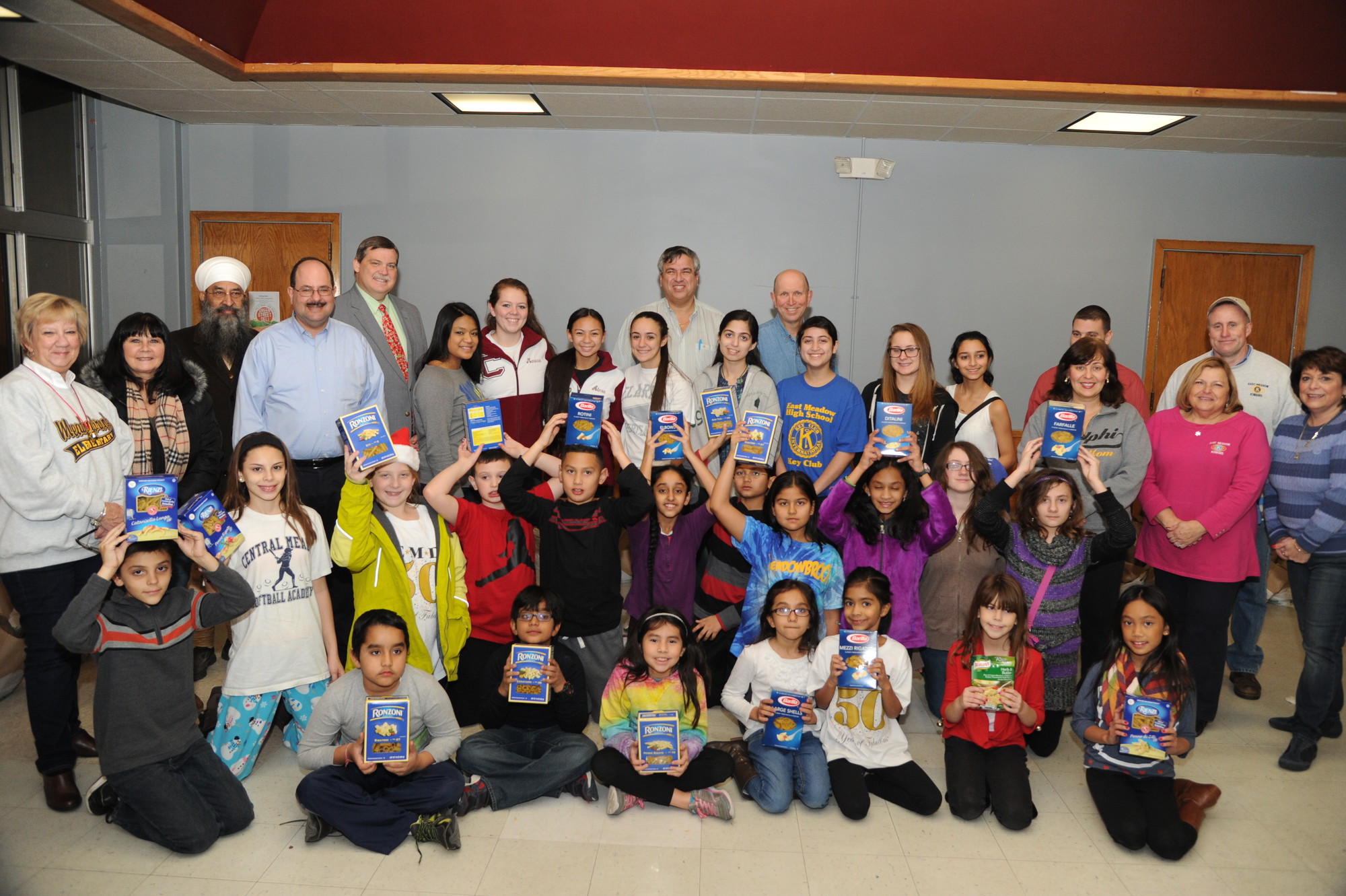 East Meadow Kiwanis club members and students sorted food last Friday that was accumulated in food drives the club hosted outside local supermarkets.
