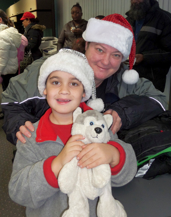Aidan Tarsia, 6, and his mother, Tina, waited at Little St. Nick headquarters in Lynbrook to board the bus to Manhattan.