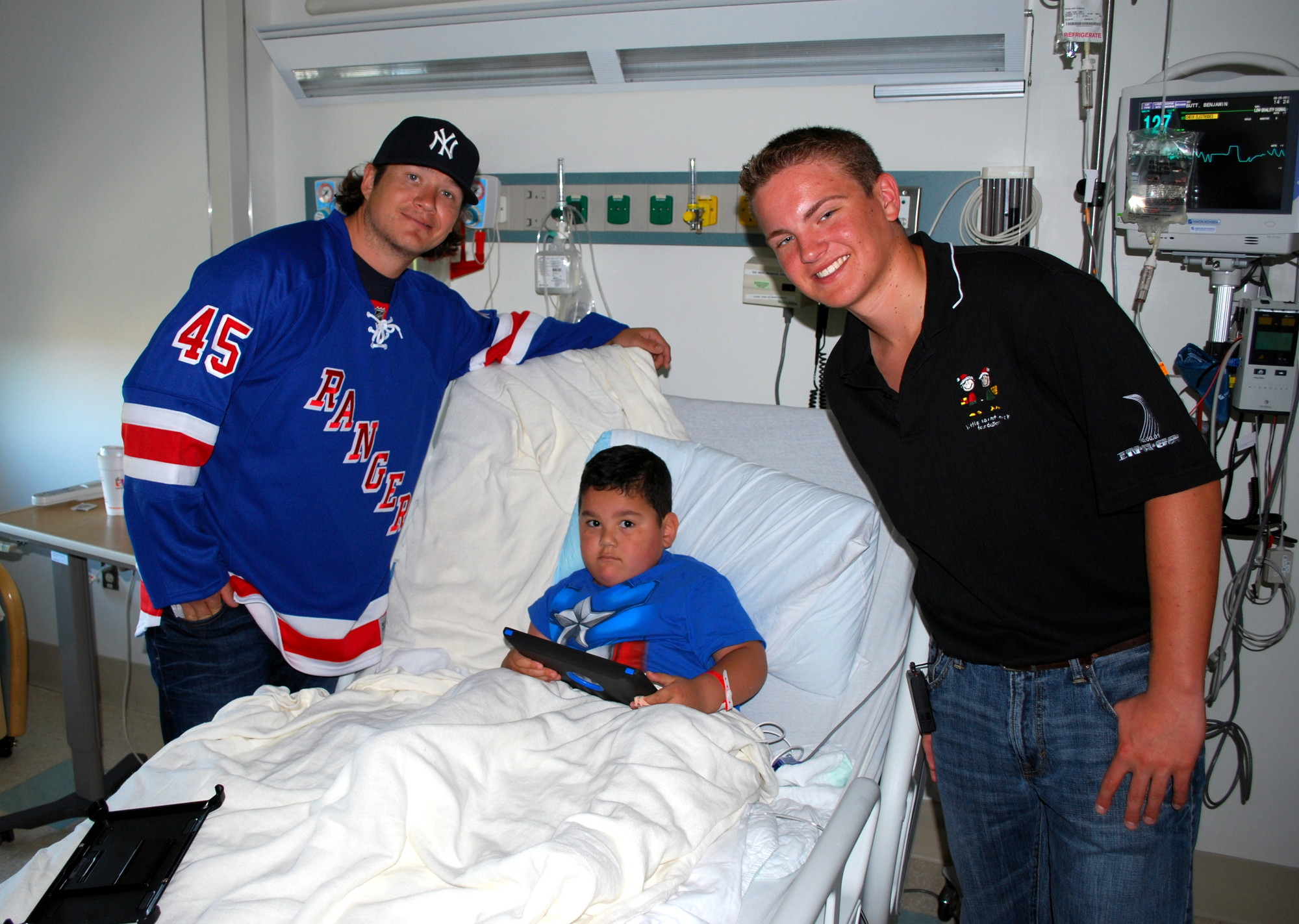 Ray Mohler Jr., right, and Rangers star Arron Asham delivered smiles and autographed pucks to young patients at Winthrop University Hospital’s Child Life Program ward in 2013.