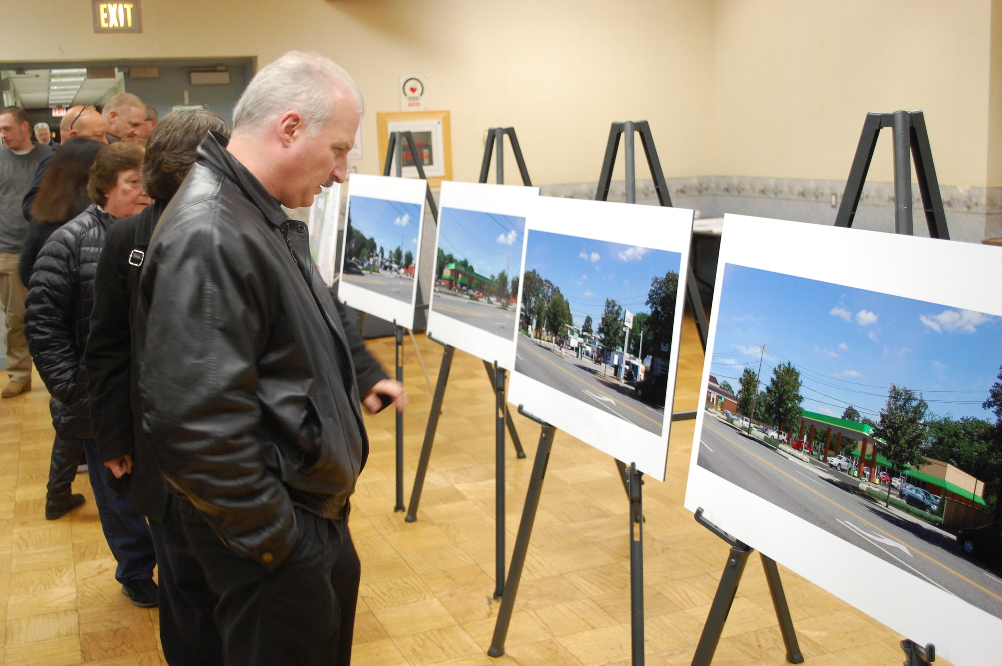 Seaford residents looked over pictures comparing the current Merrick Road site with renderings of the proposed QuickChek gas station at a community meeting on Jan. 13 at the Seaford firehouse.