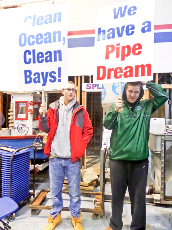 Dylan Riso, left, and Mike Weltner, both of Freeport, held signs in support of the outfall pipe.