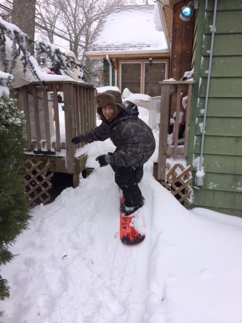 Mason Peragine, 12, snowboarded down a makeshift snow hill in his backyard.