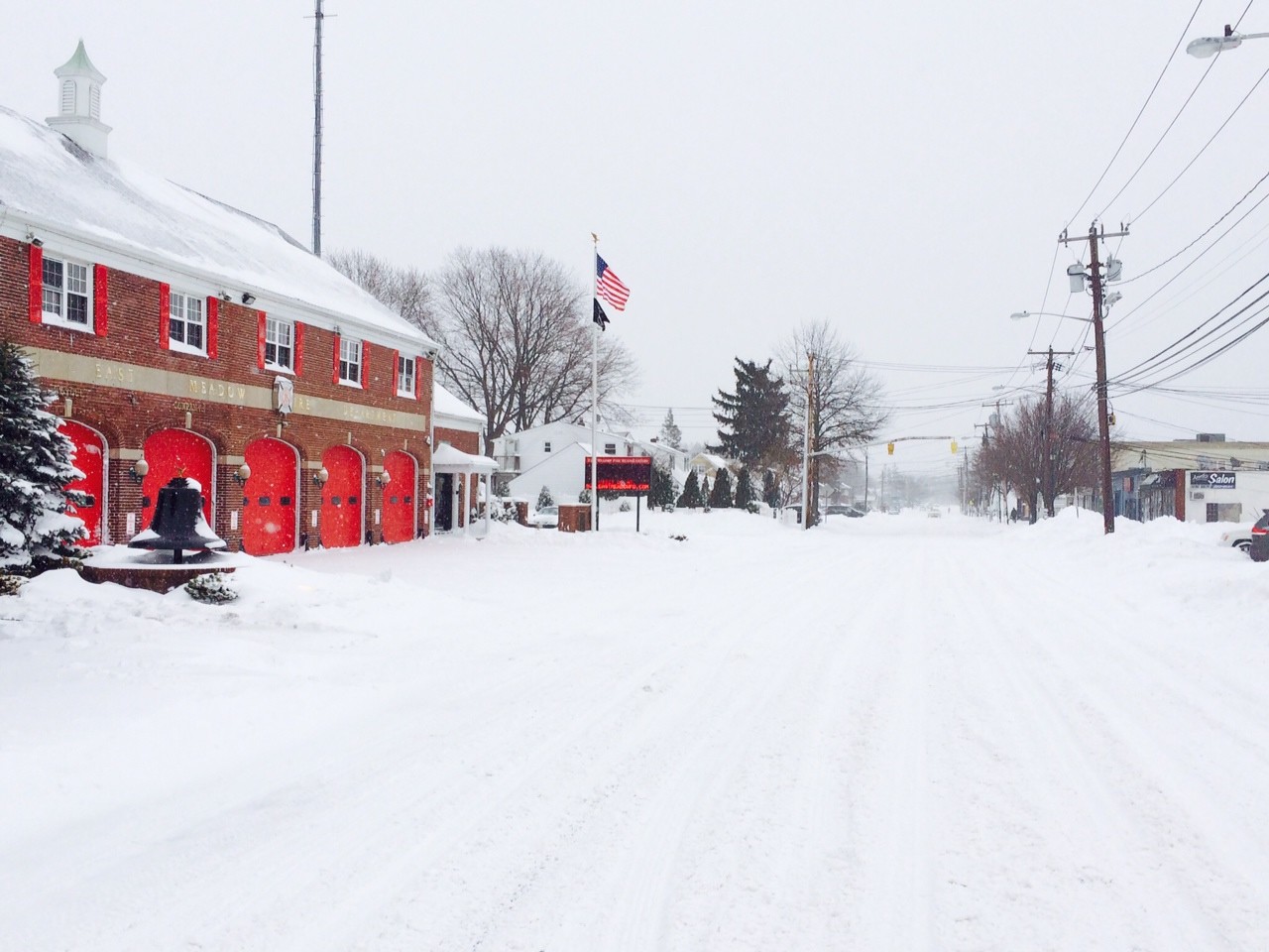The East Meadow Fire Department's red brick building on East Meadow Avenue stood out among the snowfall.