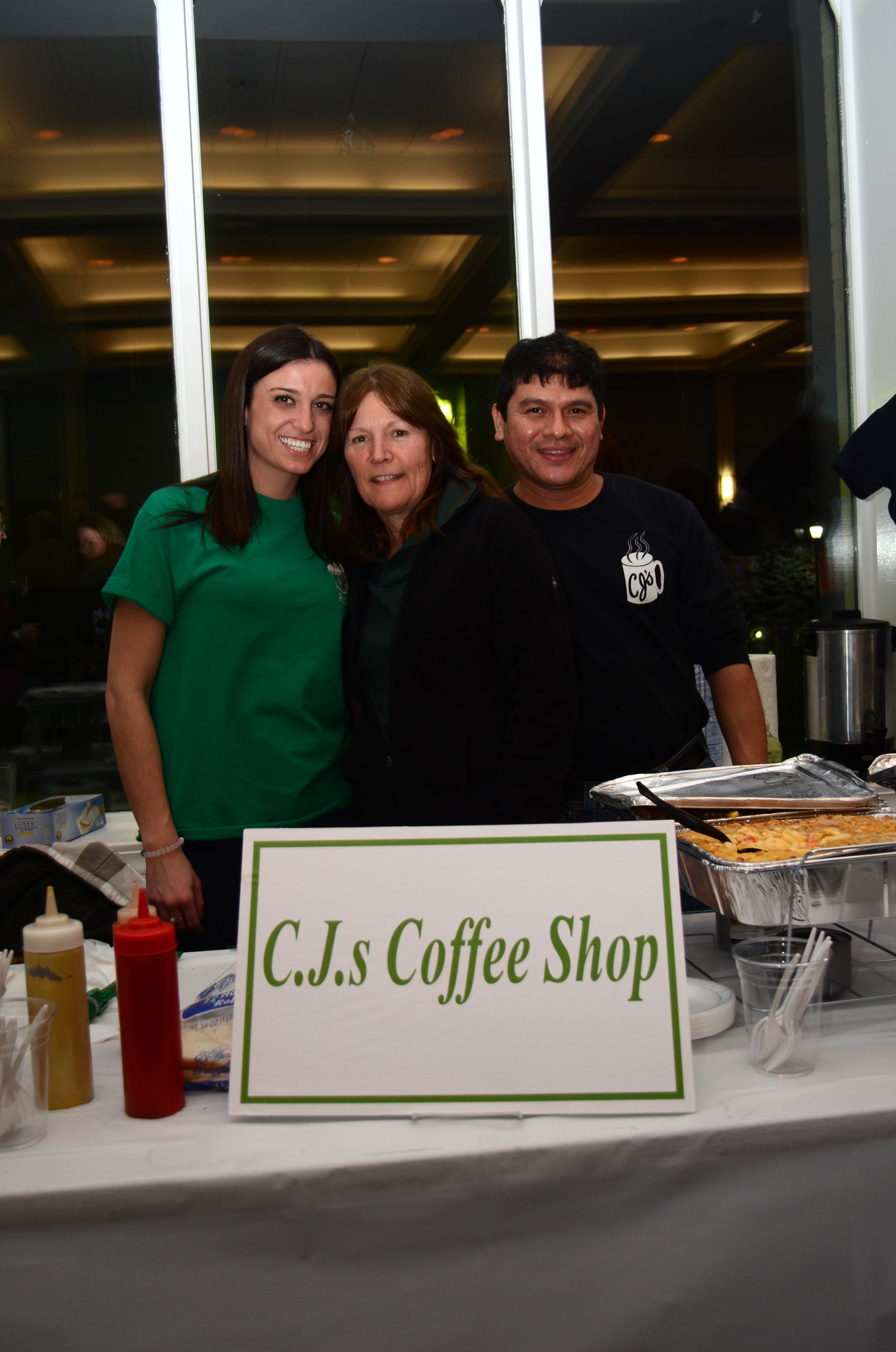 Loreen Lawrence, left, Laura Calabrese and Miguel Canales of C.J.s Coffee Shop served up hot food to the guests.