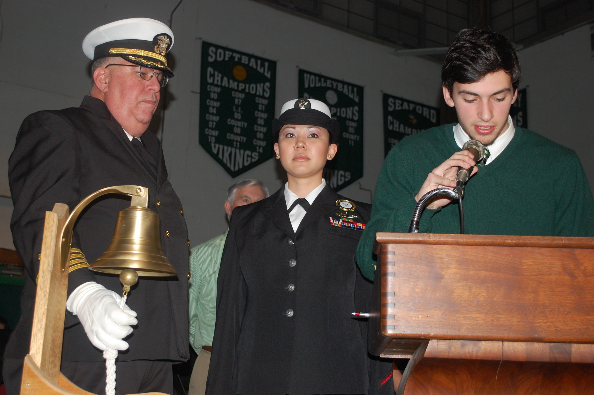 James Irwin, right, read the name of one of the Vietnam War honorees as the Rev. Ronald Chase and Petty Officer Maria Ciara Tiomico tolled a bell.
