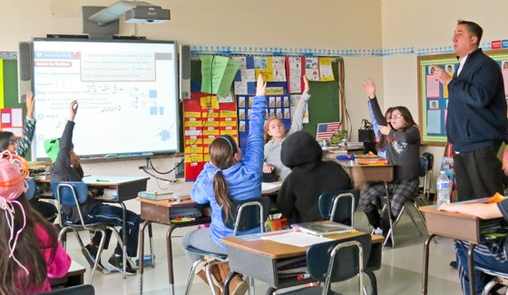 Utilizing a flipped classroom model, Seaford Manor fifth-grade teacher Chris Feiler reinforces a math lesson that was introduced to students online the night before.