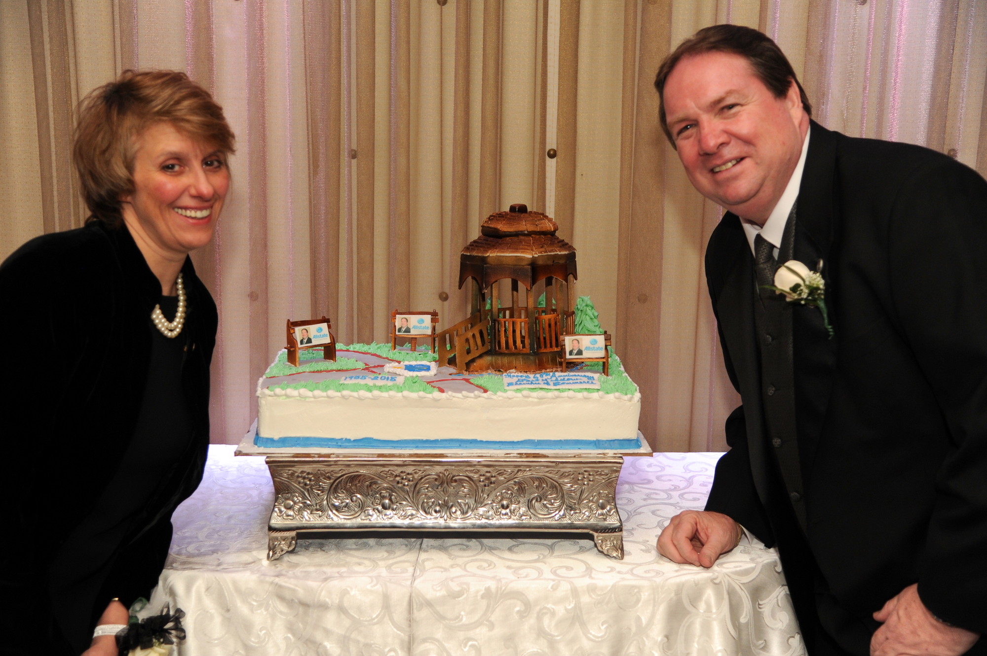 Walter Skinner, who the Chamber honored as Person of the Year, with Rose Fuger of a Taste of Home, admired a cake designed to replicate Veterans Memorial Park in East Meadow,