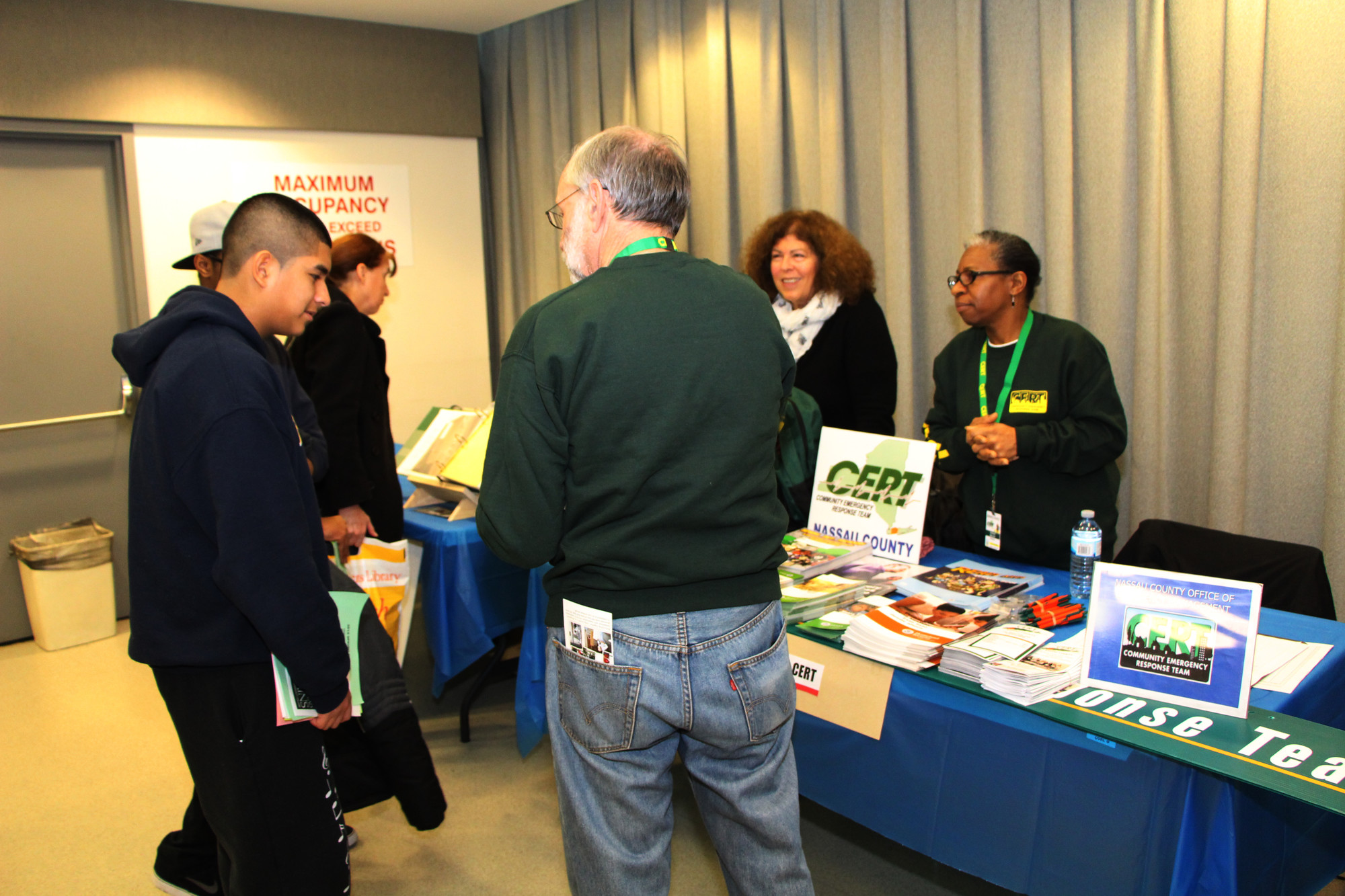Hamisi Lewis and Steven Ardiles, of Baldwin High School, inquired about the Nassau County CERT program. CERT members Judy Pique, center, Marvolid Stennett, right, and George Trepp were happy to answer their questions.