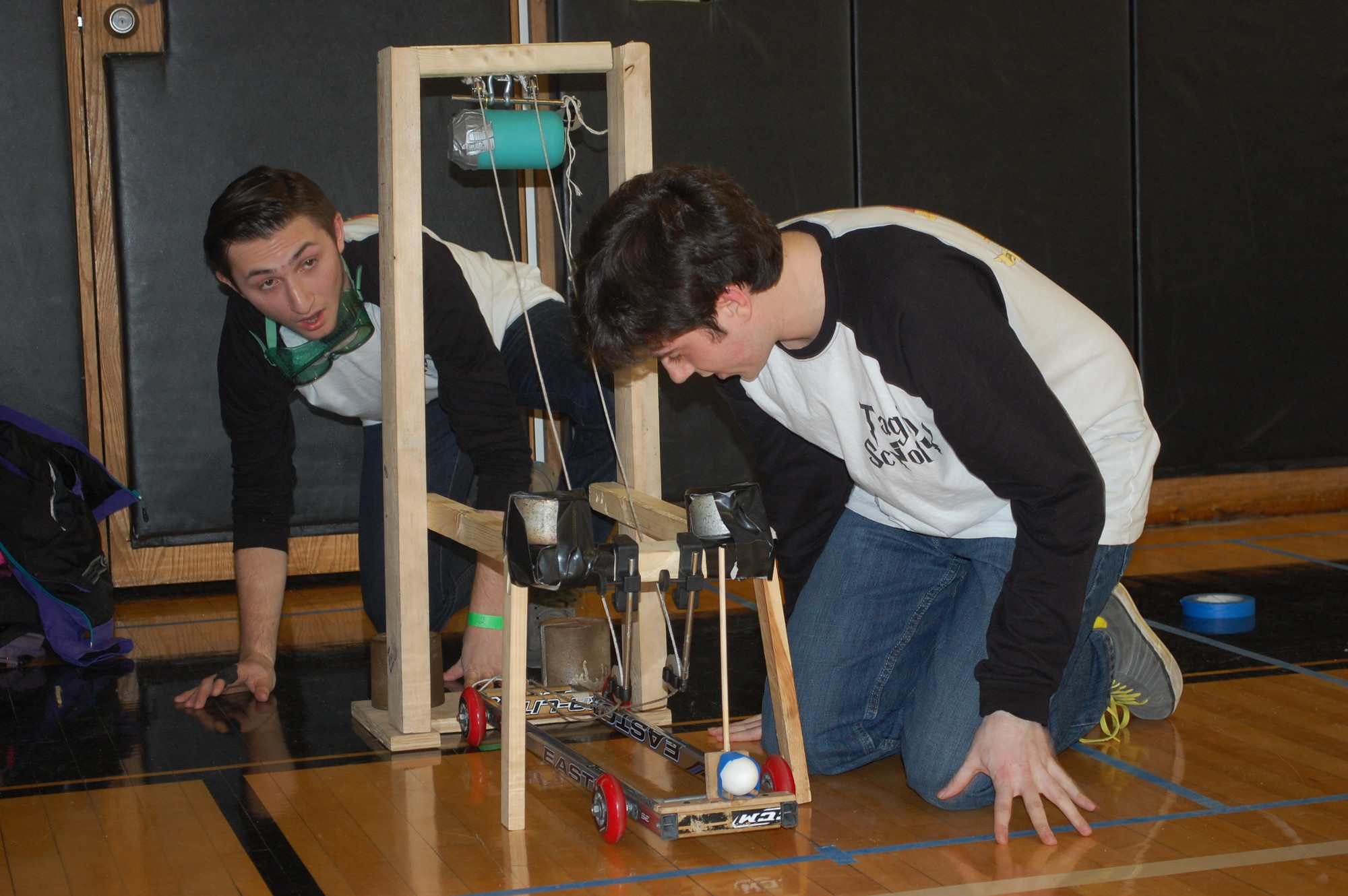 Wantagh High School seniors Zach Diaks, left, and Kyle Rhodehouse set up their machine in the Scrambler event at the Science Olympiad regional competition on Jan. 31.