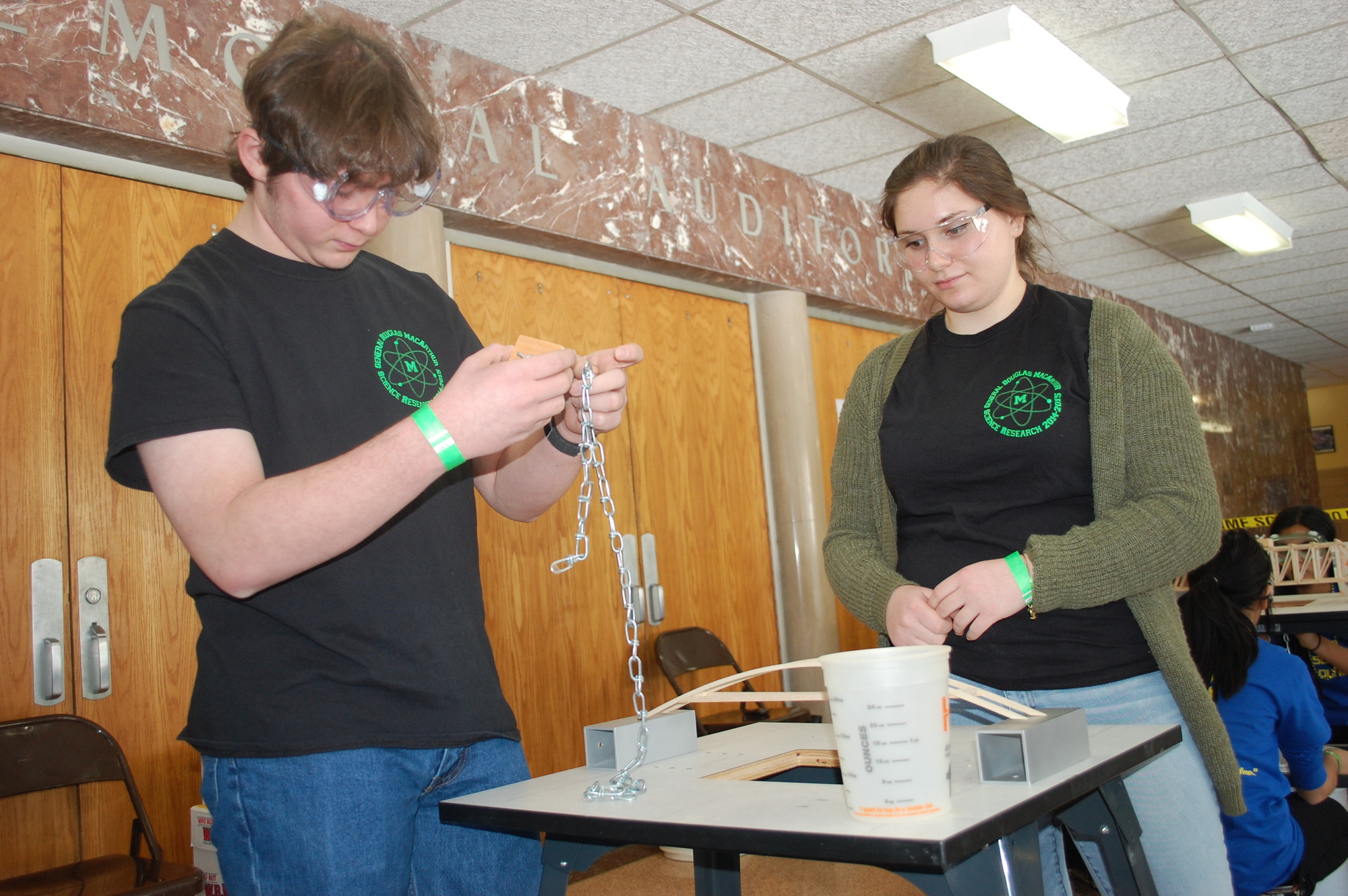 MacArthur students Max Richman and Sabrina Chasen prepared to test the durability of the wooden bridge they built.