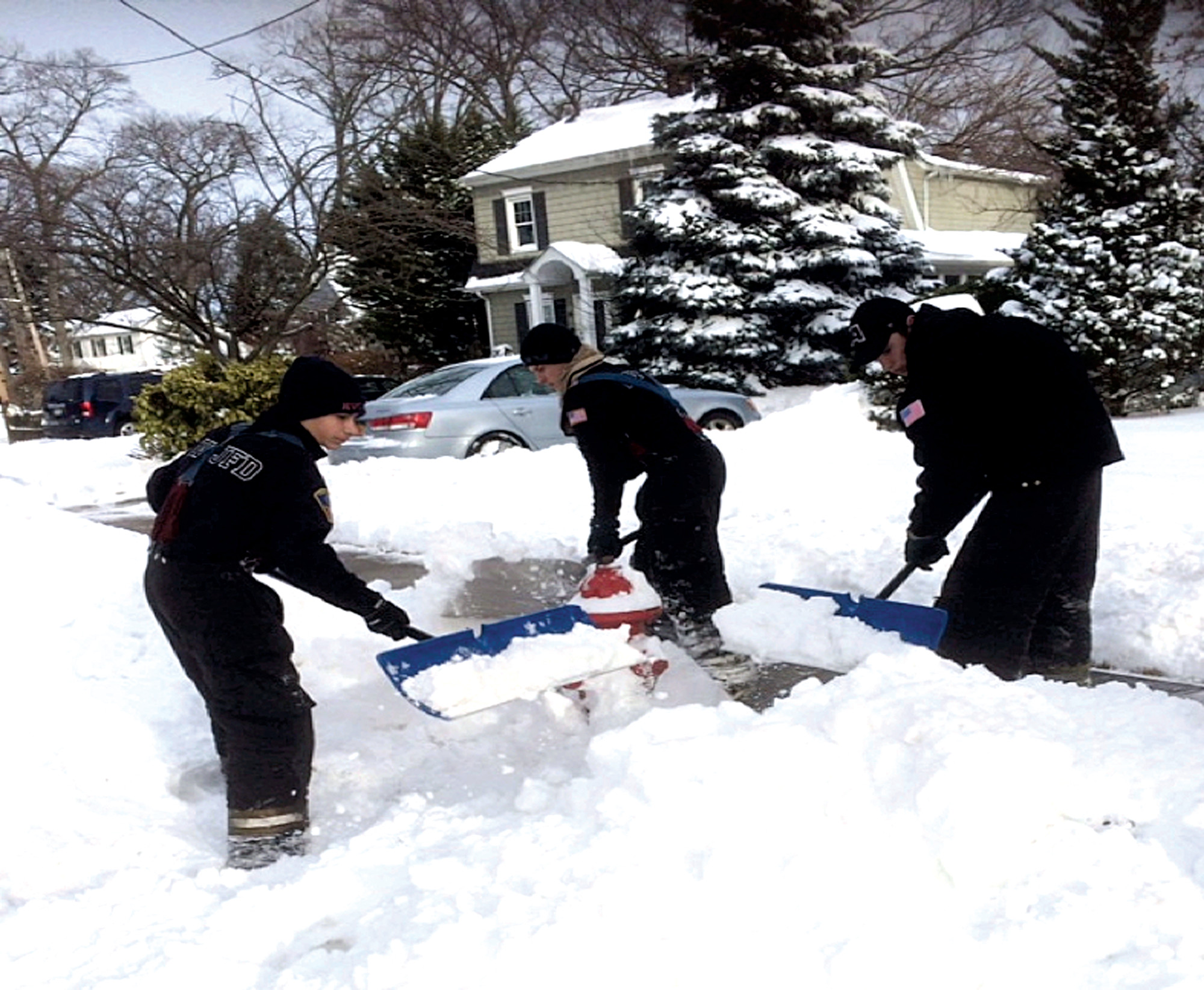 Junior Firefighters Lieutenant Johnny Cook, left, Michael McGovern and Patrick Leach assisted the department by clearing snow from fire hydrants.