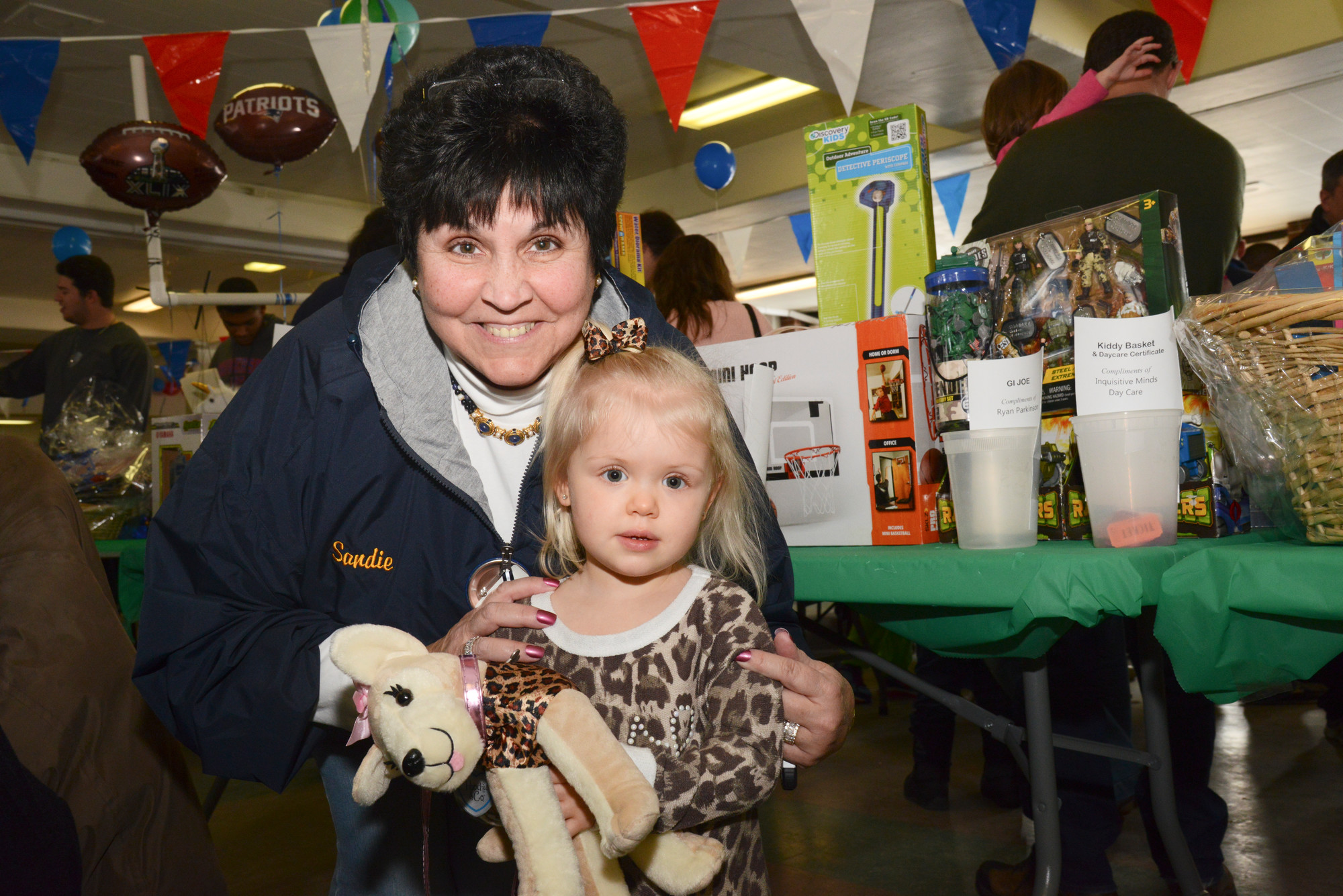Sandie Schoell and granddaughter Brianne, 2, check out the raffle prizes.