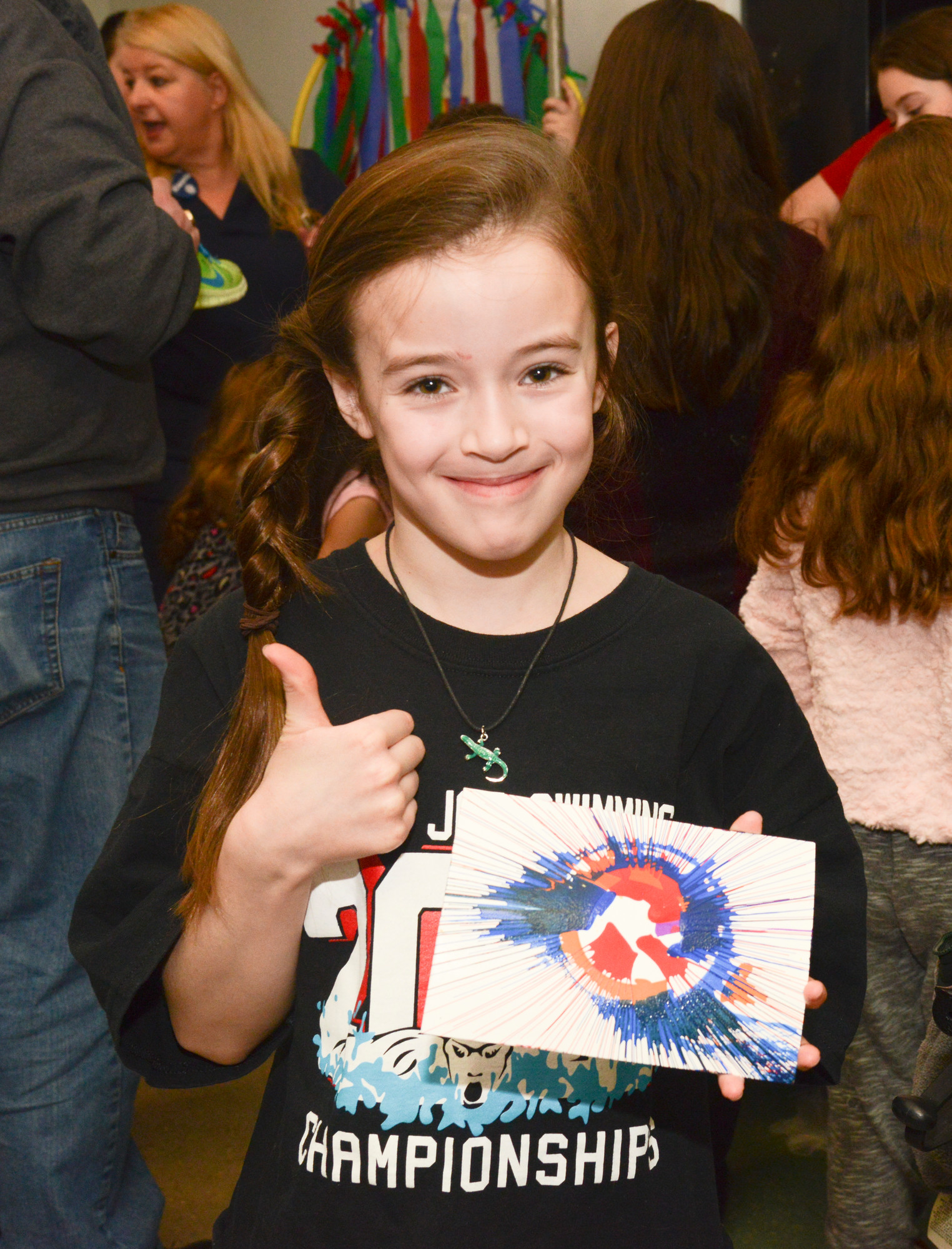 Victoria Brazill, 8, shows her spin art, one of the activities for children at the annual Kiwanis pancake breakfast