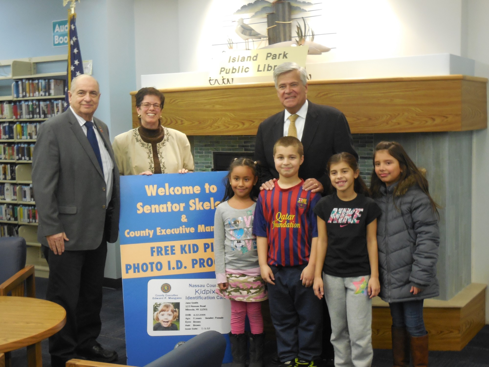 Island Park Library board member Joe Ponte, Library Director Jessica Koenig, and Senator Dean Skelos helped local children.