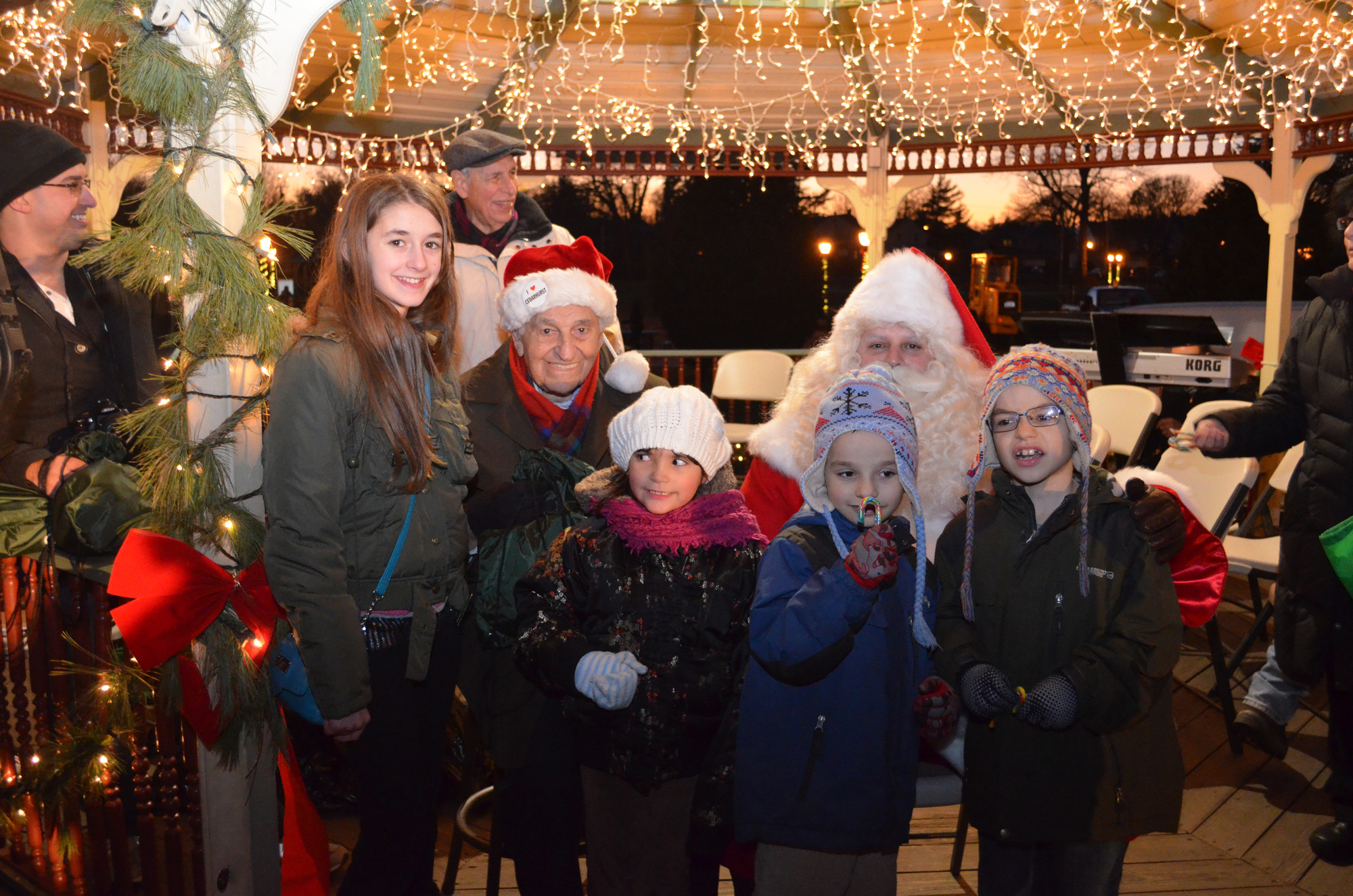 Cedarhurst Mayor Andrew Parise could usually be found in the middle of any village event. From left, at last December’s annual holiday celebration and tree lighting, were Silvia Carlo, Parise, Isabela Iasevoli, Mark and Matthew Iacomino, and Santa Claus.
