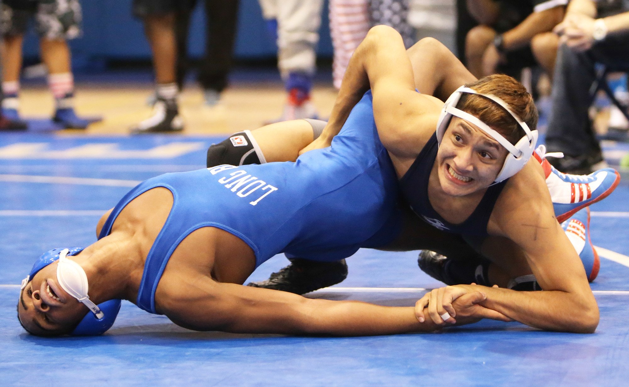 Oceanside’s Kash Calderon, right, captured the 126-pound title at the Nassau wrestling qualifier hosted by Long Beach last Saturday with a 5-4 victory in double overtime in the finals.
