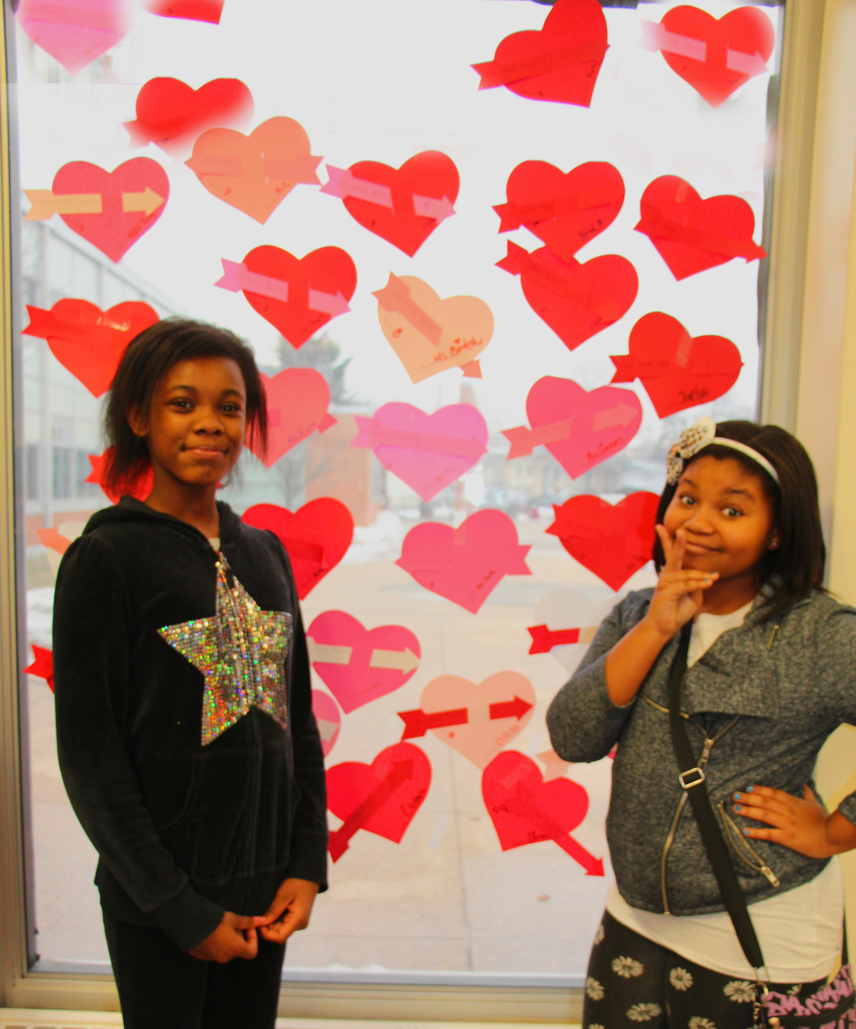 Jonyce Fels-Aime, 13, left, and Niya Sexton, 12, posed by some handmade hearts.