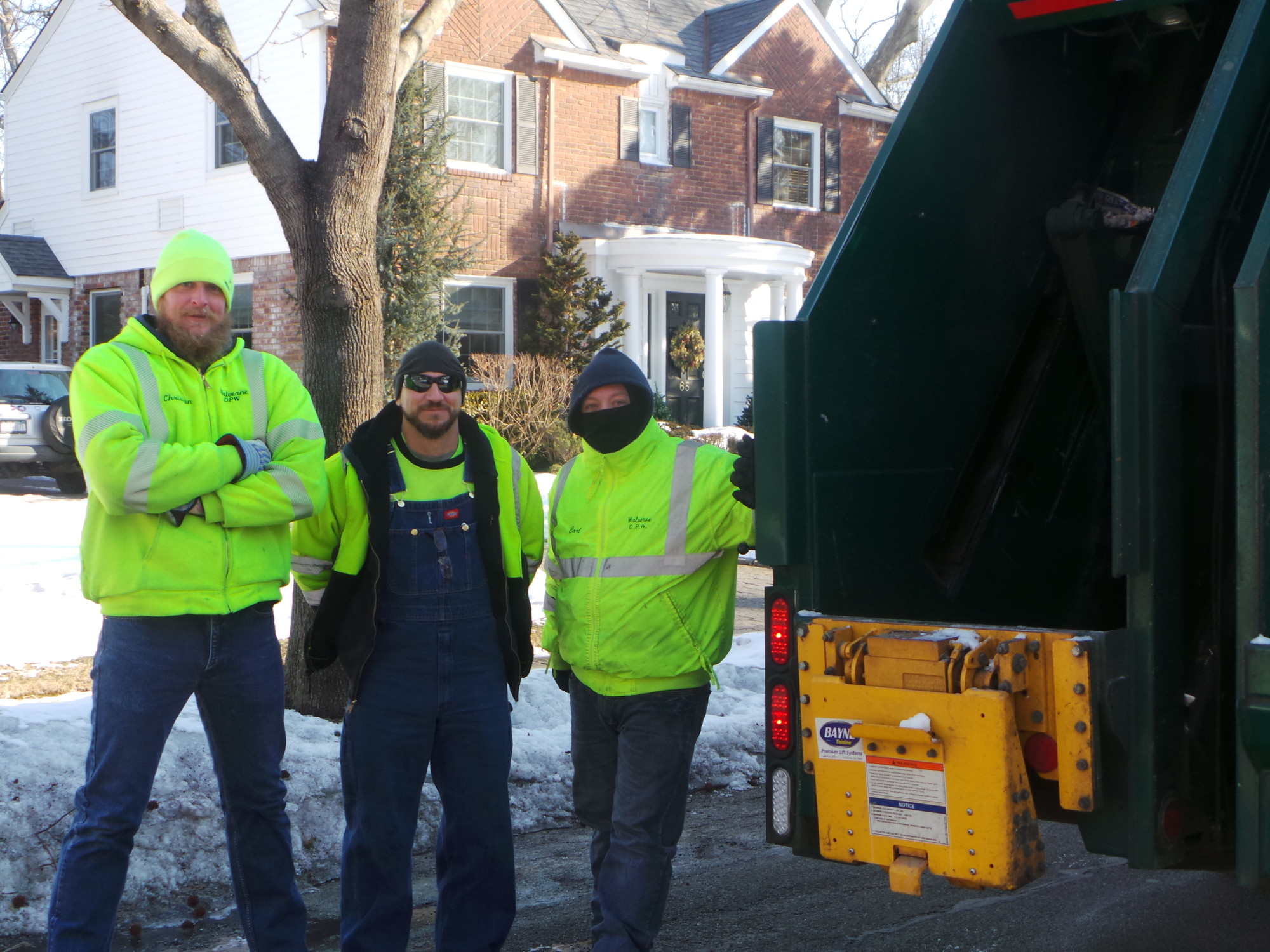 From Malverne’s Department of Public Works, Christian Stolba, Dave Terrizzi and Carl Guadagno, left to right, manage the Friday morning garbage pick-up with a smile and a great sense of comradery despite the weather.
