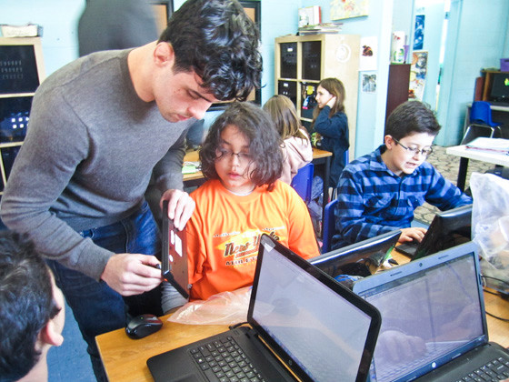 Hofstra University senior Joe Booth helped a student at the Progressive School of Long Island, in North Merrick, on Feb. 13. Booth is teaching at the school’s Next Generation Computer Programming Academy this year.