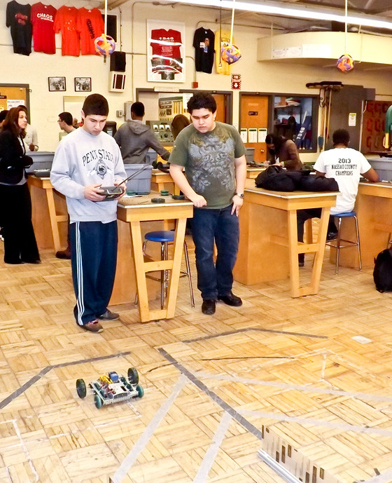 Seniors Emanuel Gerardino, left, and Daniel Palacios tested their robot during Tilles’ visit.