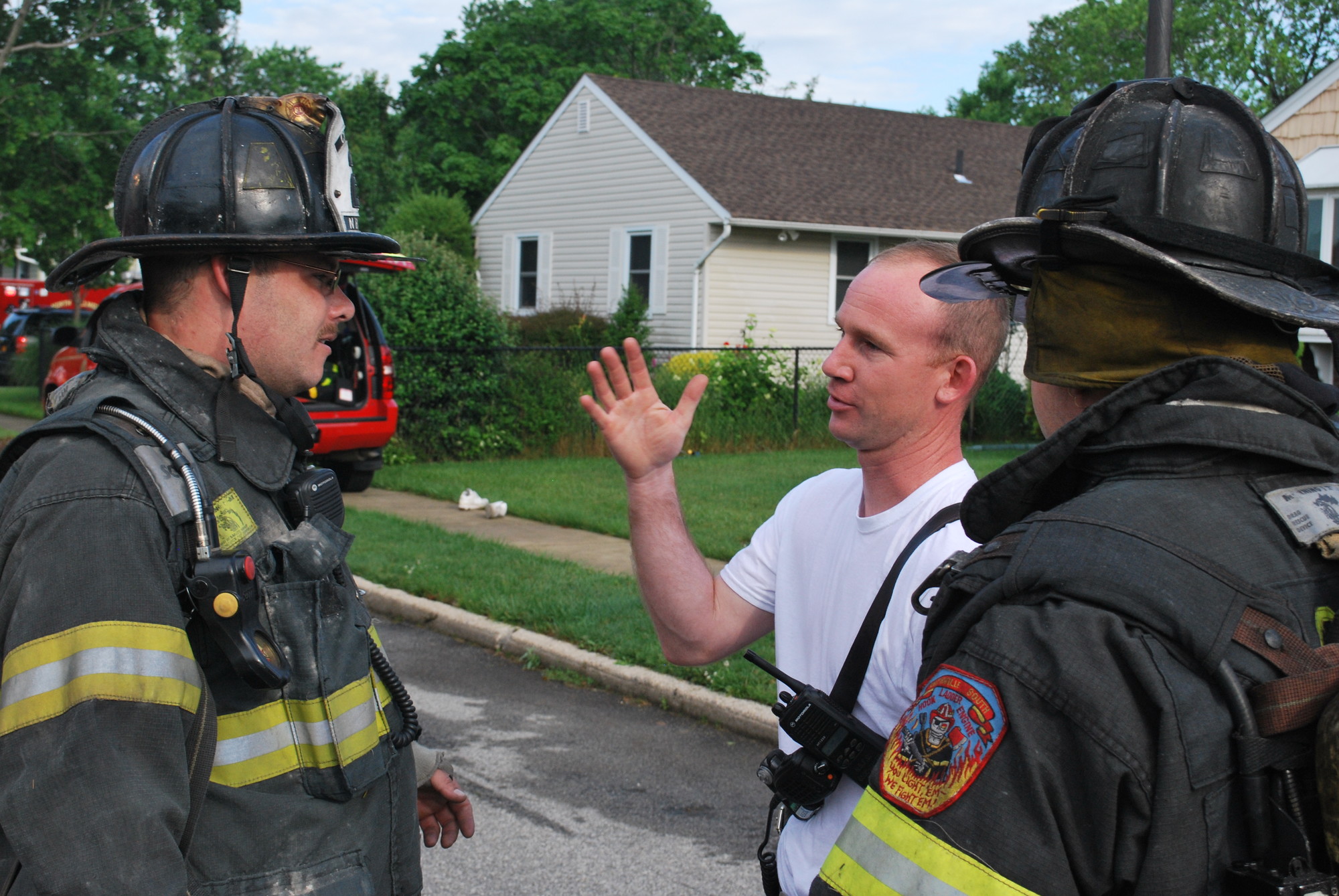 Collins, center, was a chief of the North Bellmore Fire Department from 2010 through 2014. He is pictured above working with firefighters on the scene of a basement blaze in a local home on June 17, 2013.