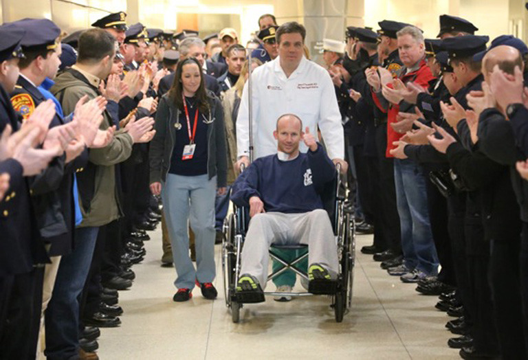 Dozens of well-wishers turned out when officer Mark Collins left Stony Brook University Medical Center on Sunday.