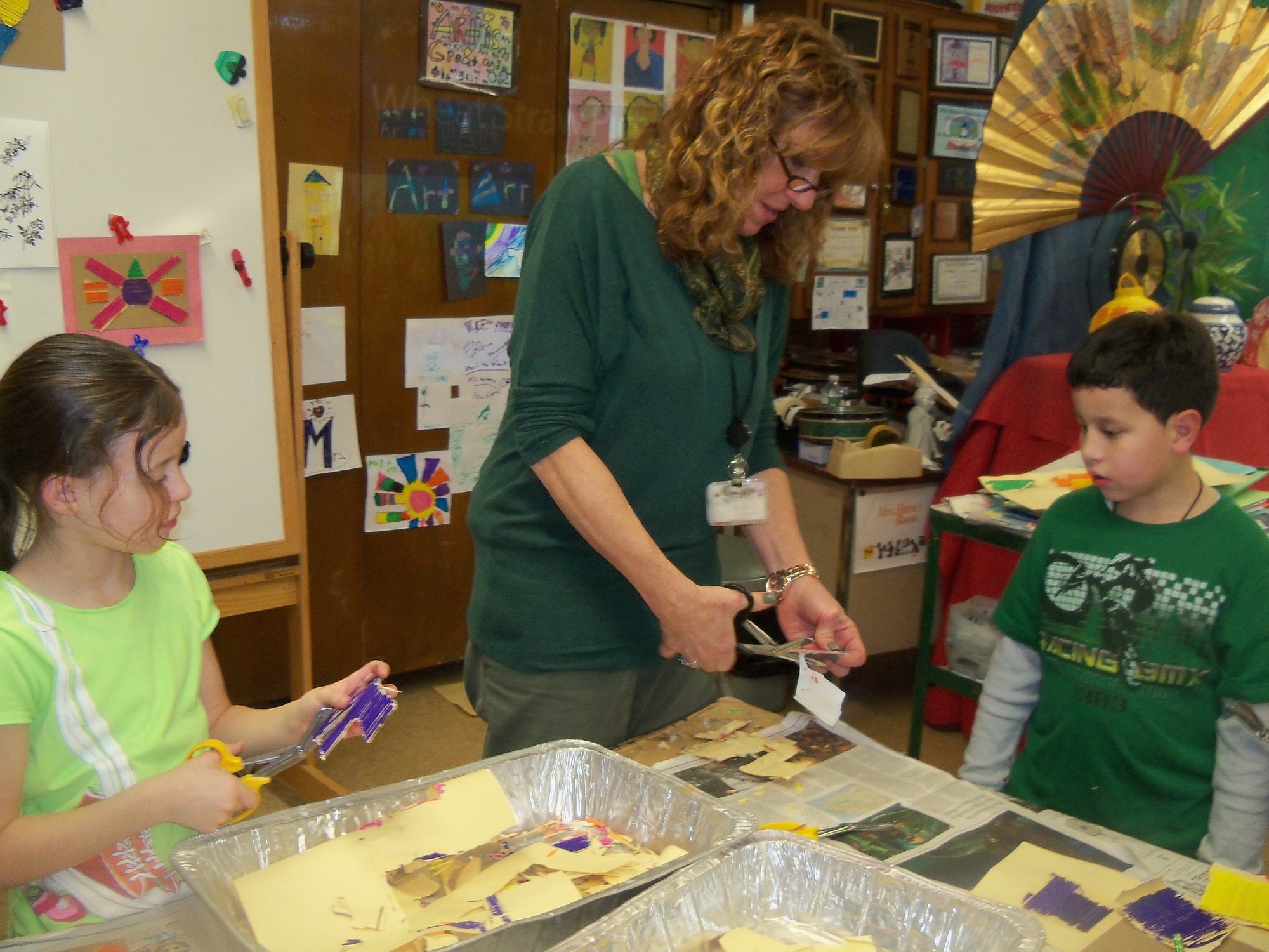 Art teacher Diane Horn is shown here helping second grader Miguel Cardona-Yepes with his creation. The district-wide art show will be held May 4 from 6-8 p.m.