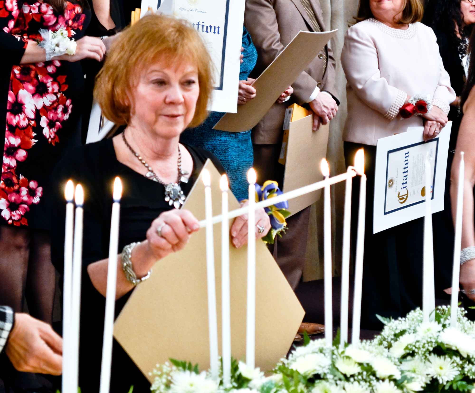Susan Lennon, an honoree from East Meadow High School’s PTA, lit a candle after her name was called.