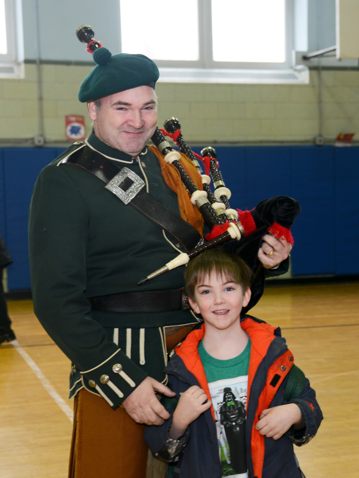 Bagpiper Joe Beyrer and son James, age 6, at School 6 in Oceanside.
