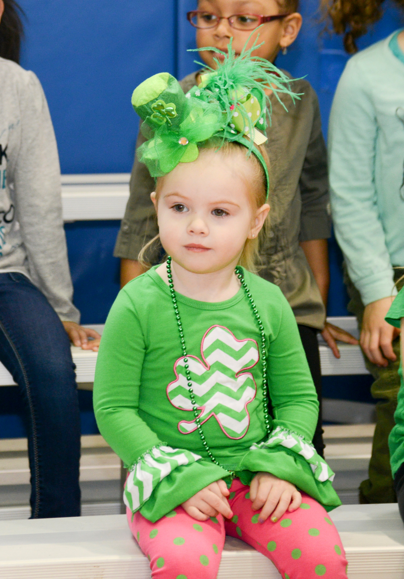 Emma Corcoran watches the bagpiper play for St Patricks day.
