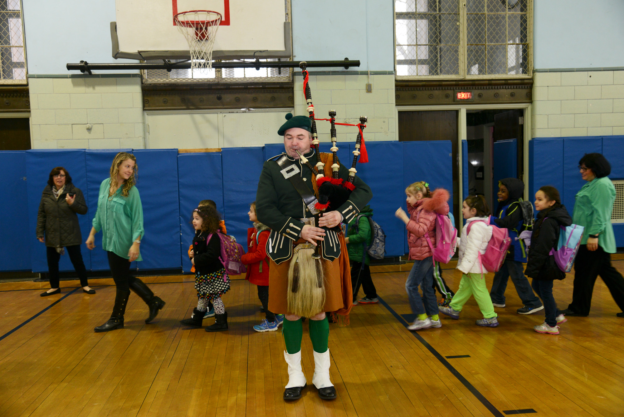 Bagpiper Joe Beyrer plays as students enter the gym  at school 6 in Oceanside.