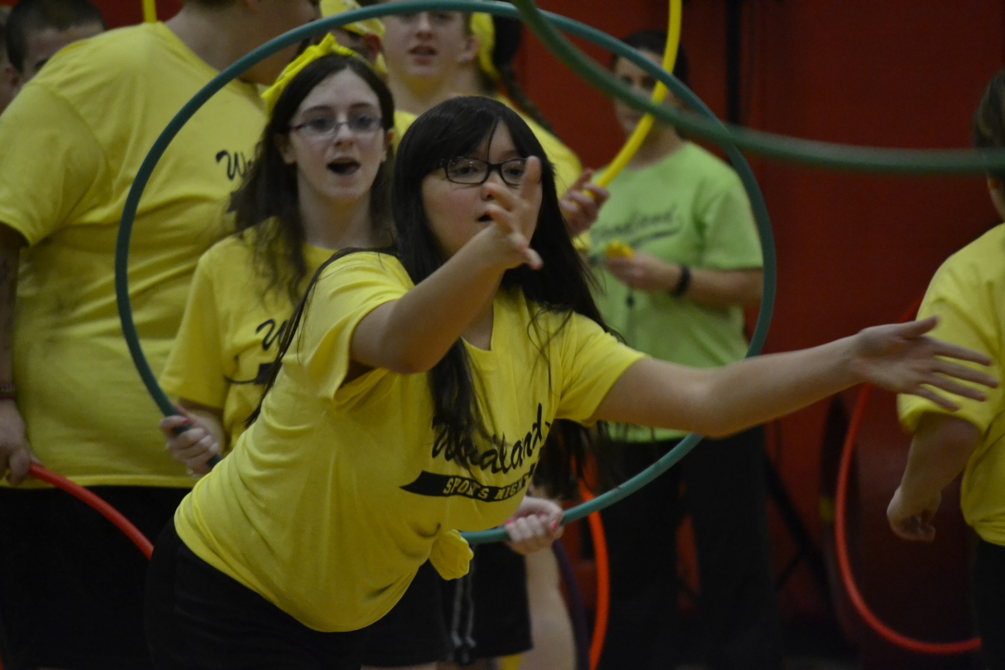 Students from the yellow team threw hula hoops.