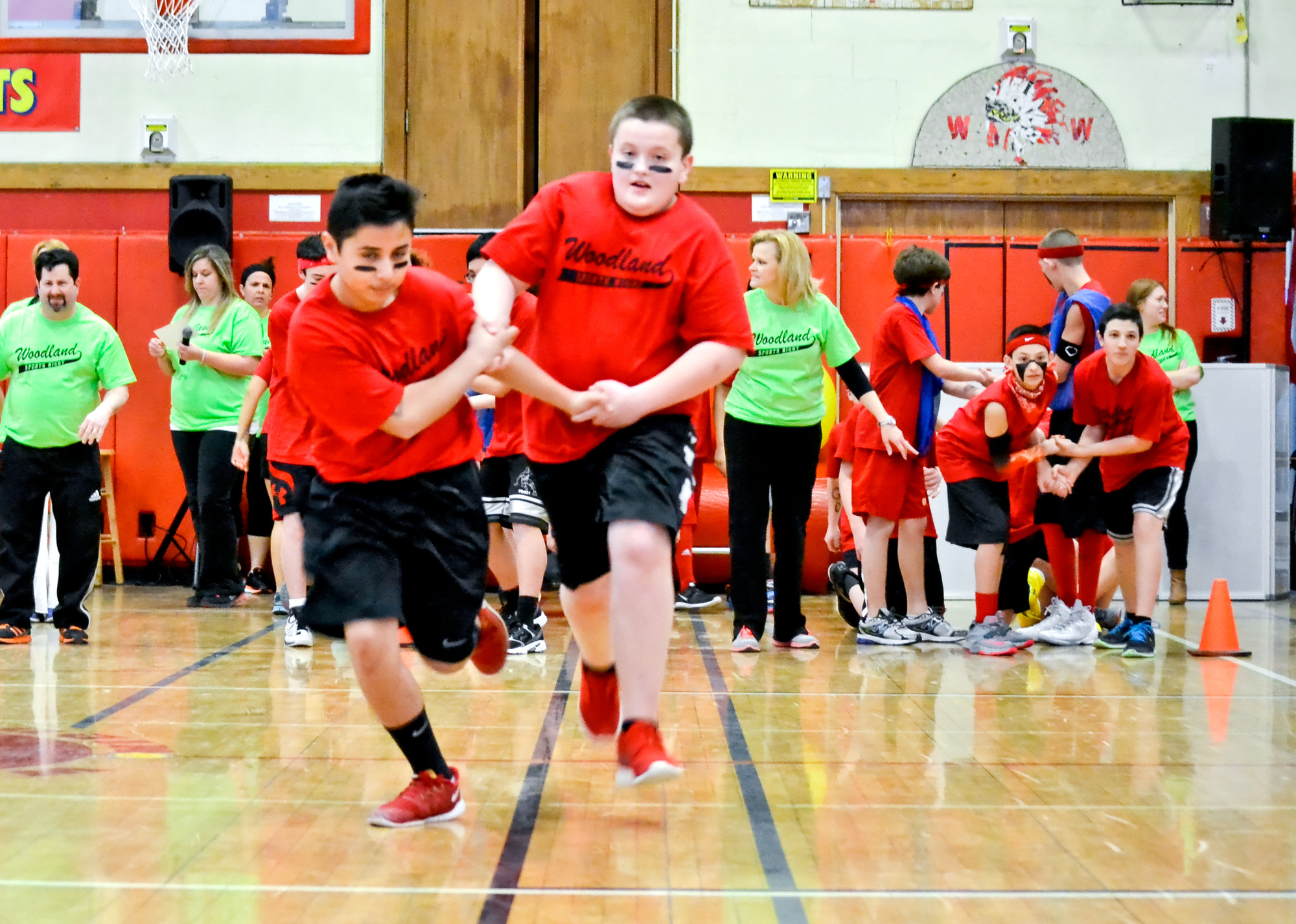 Andy Arrieta, far left, and Joe Monteleone raced in the partner relay at Woodland Middle School’s Sports Night last Thursday, a friendly competition among eighth-grade students.