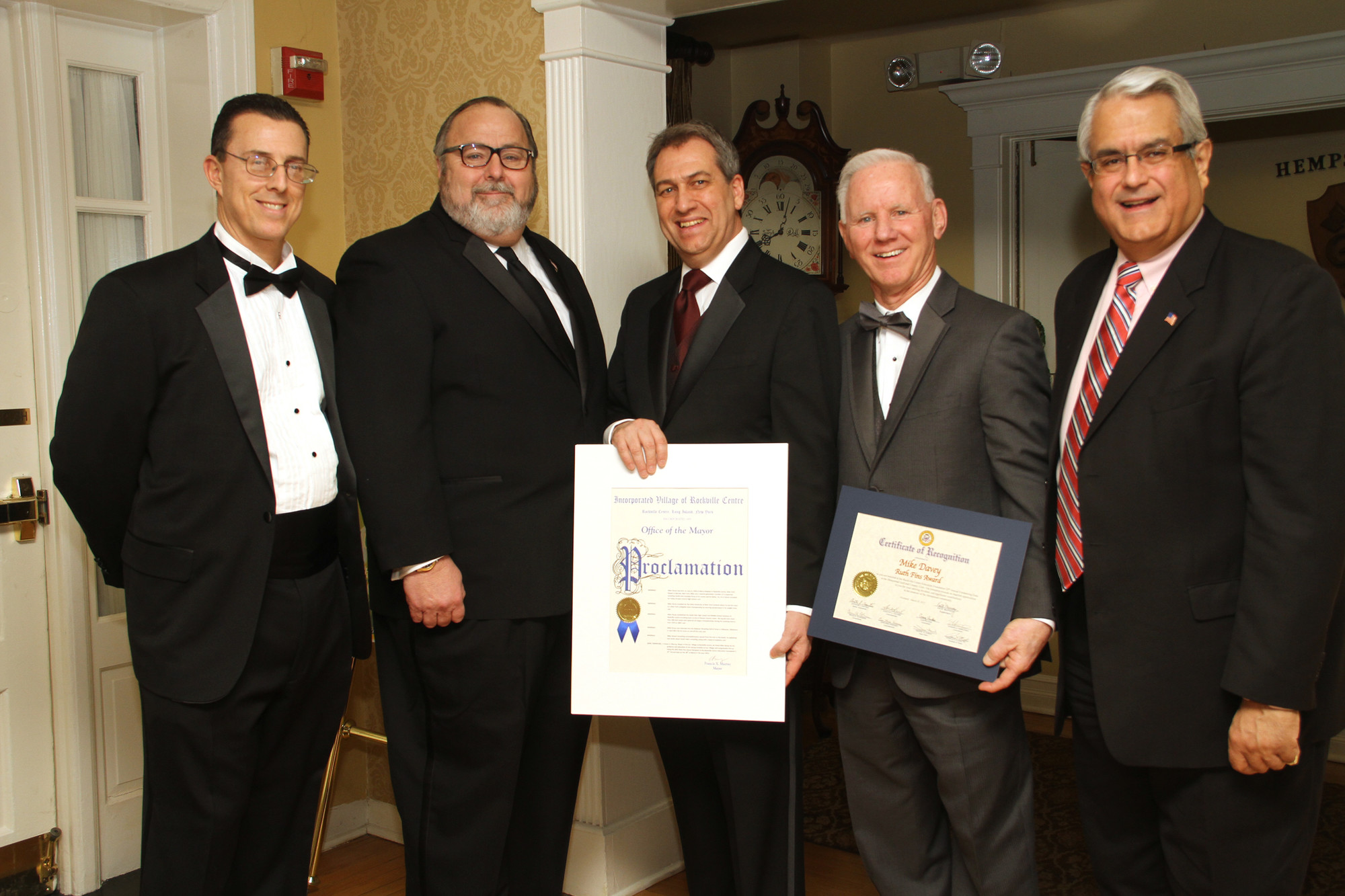 Honorees Dr. Drew Bogner, center, and Mike Davey, second from right, were congratulated by Education Foundation President Joel Ditchik, left, Rockville Centre Mayor Francis X. Murray, and Town of Hempstead Councilman Tony Santino.