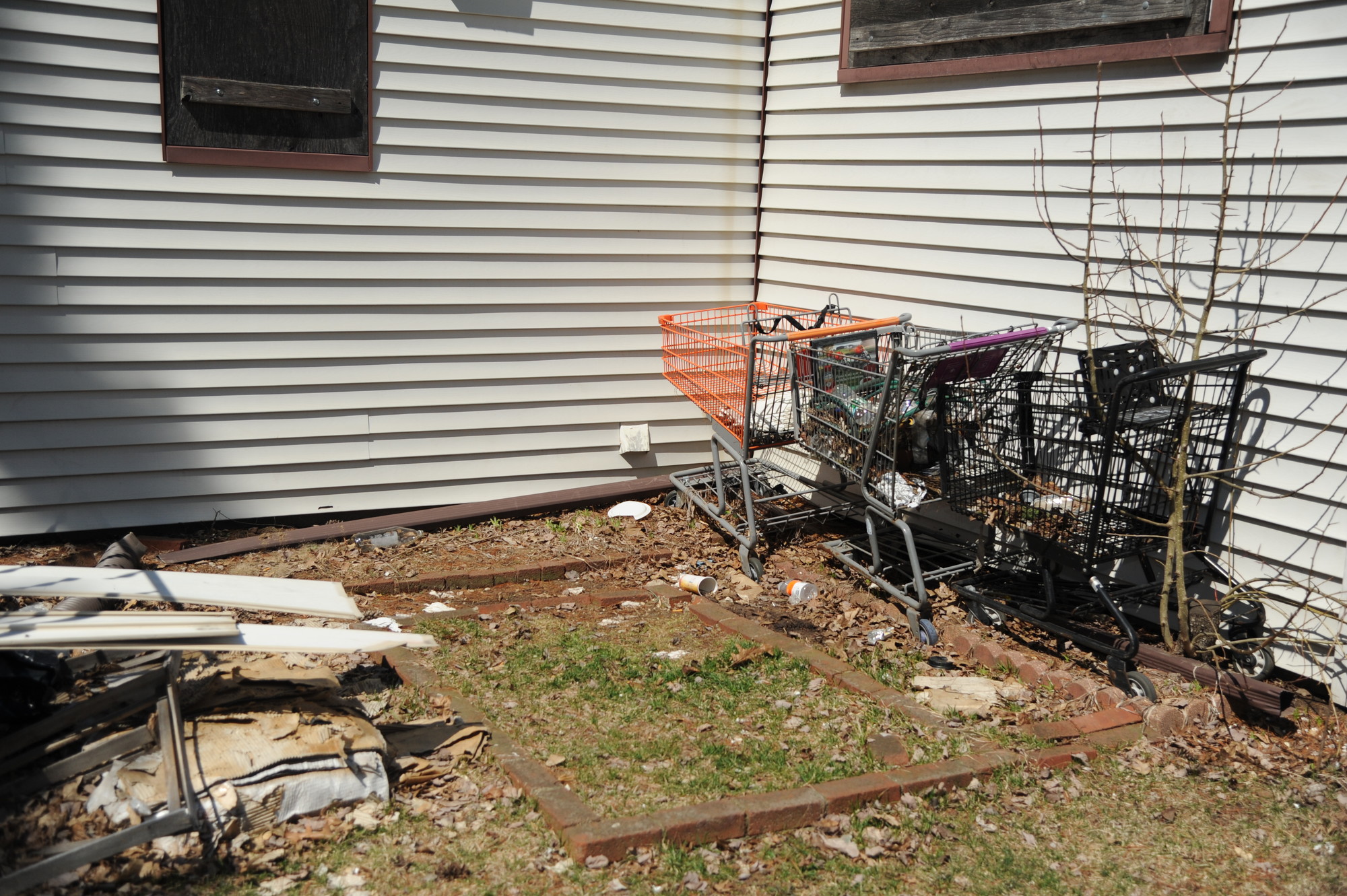 The prevalence of shopping carts has led many to suspect that squatters may occupy the abandoned house.