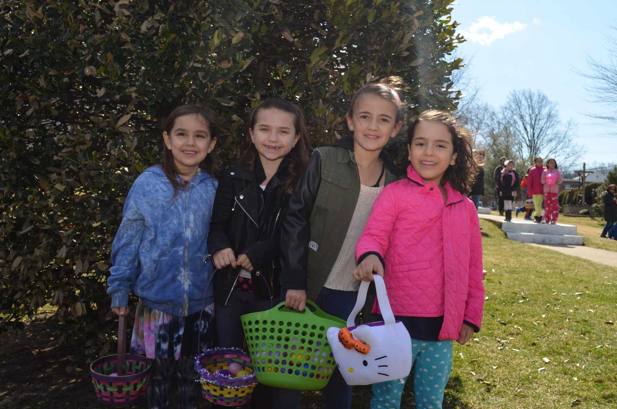 The egg hunt was good to sisters Lore, 6, Gabriella, 7, and Jule, 8, Villalba and friends Francesca Garcia Rocha, 6, all Hewlett residents as they showed off their baskets.