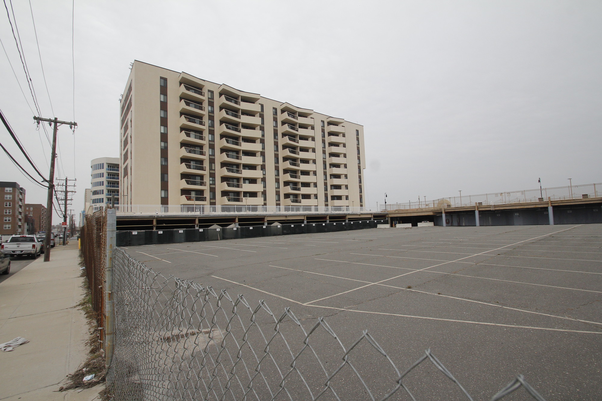 A developer alleges that the city zoning board bowed to pressure from unit owners of Sea Pointe Towers, above, at 360 Shore Road, when it revoked permits for the construction of adjacent condominium buildings.